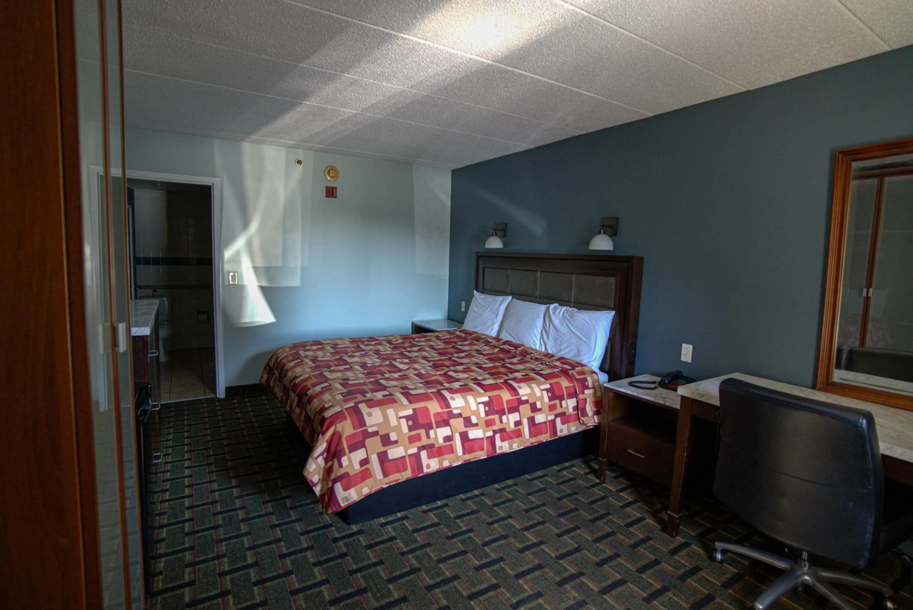 Bed in Excel Inn & Suites