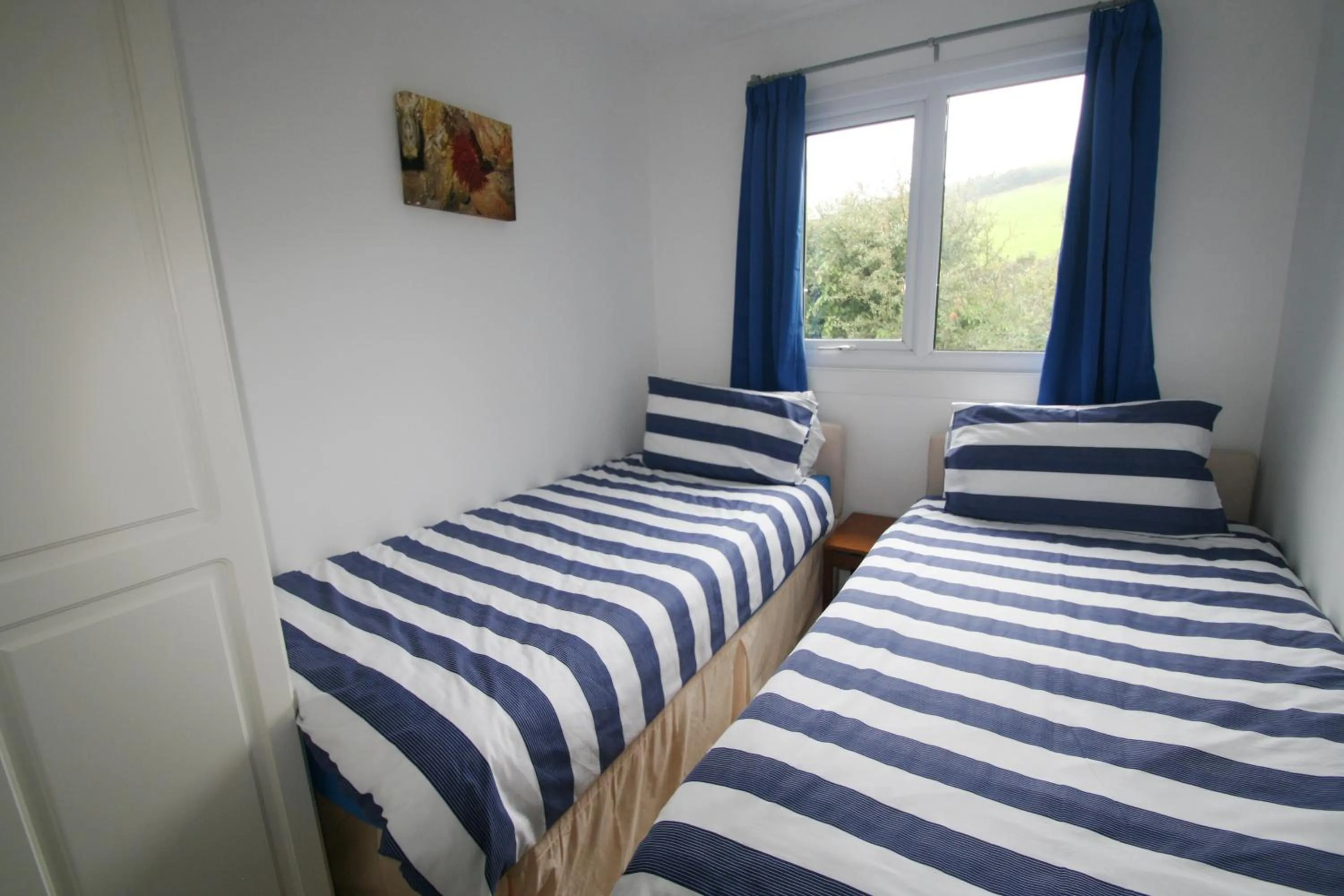 Bedroom, Bed in Freshwater Bay Holiday Cottages