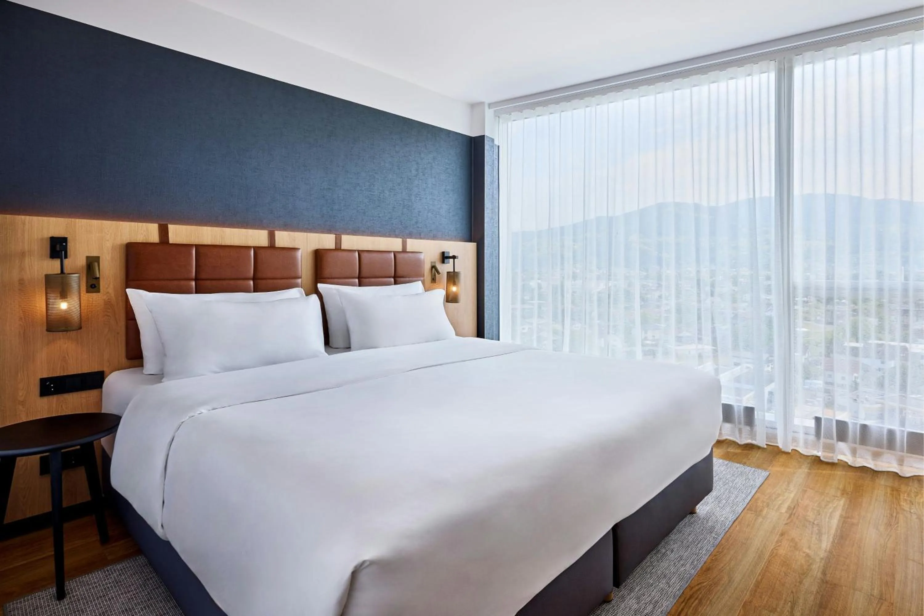 Photo of the whole room, Bed in Four Points by Sheraton Panoramahaus Dornbirn