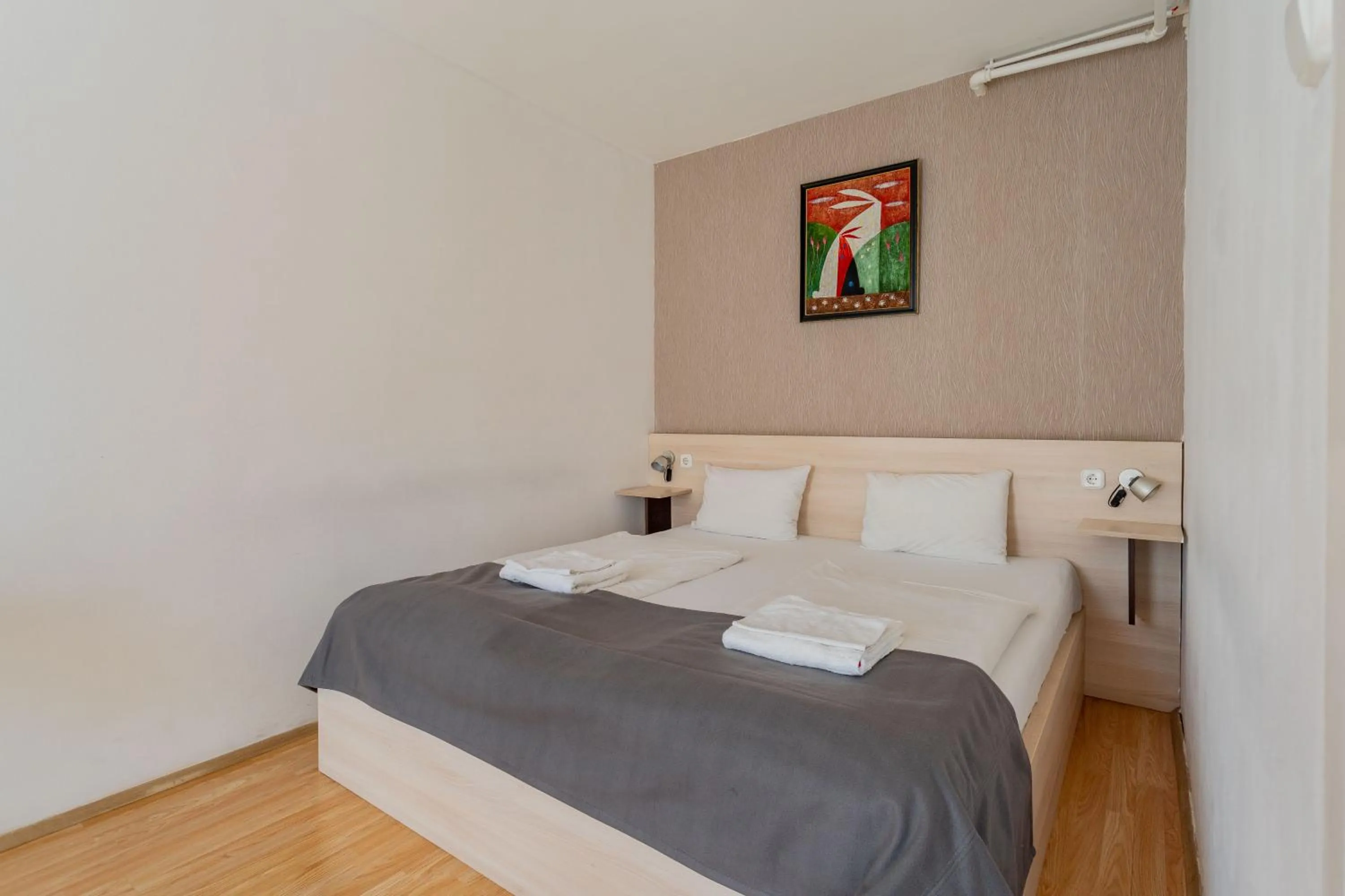 Bed in Triple M Hotel