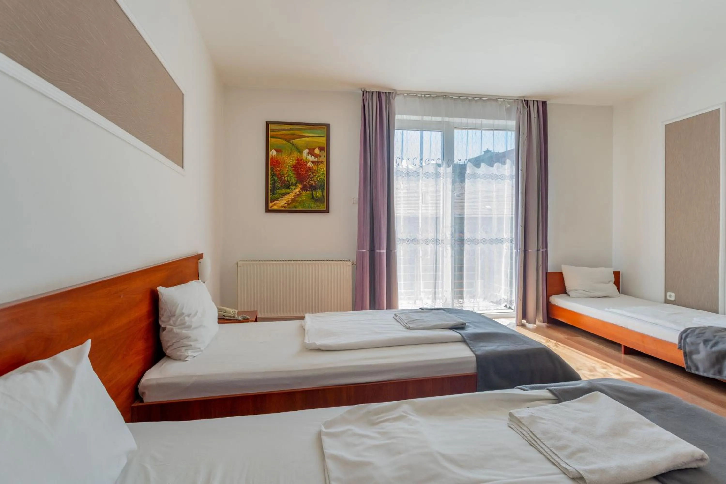 Bed in Triple M Hotel