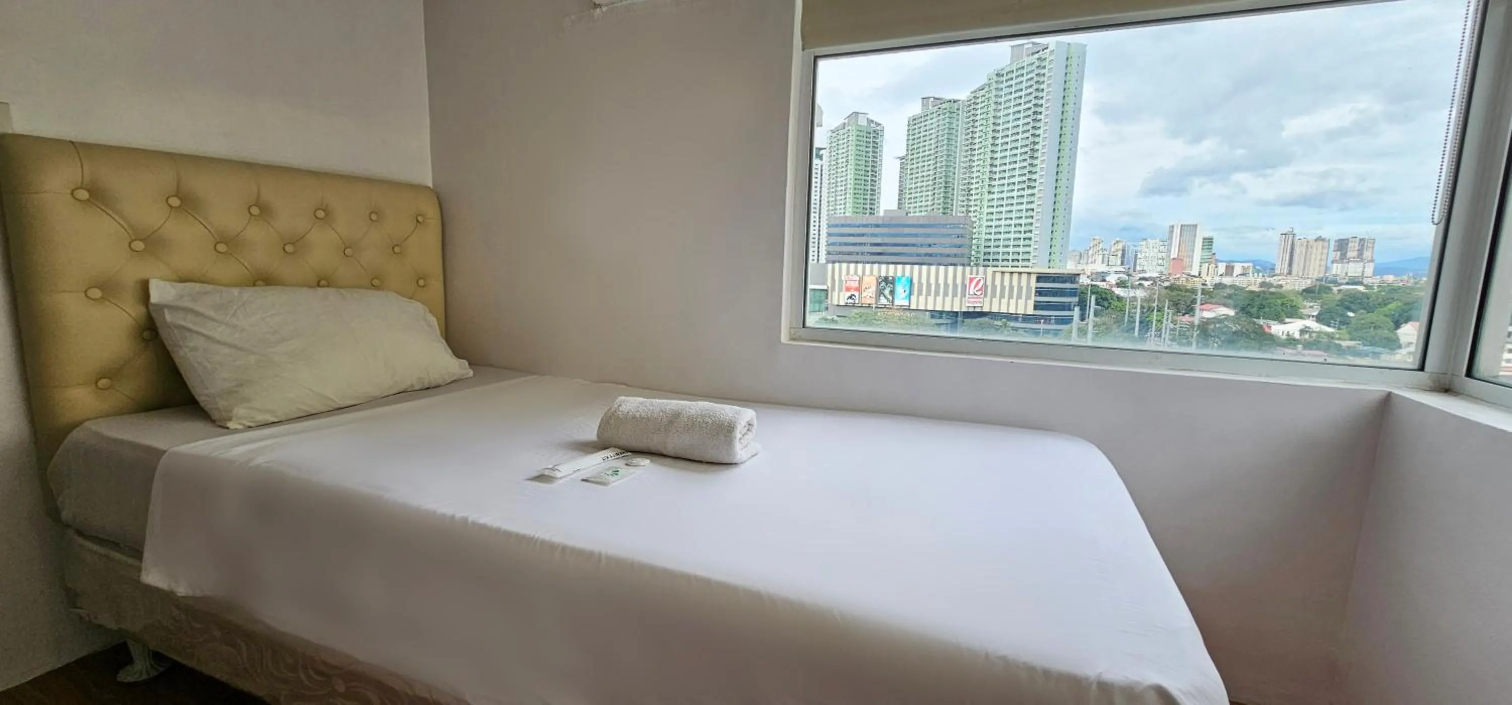 Bed in Gilmore Tower Suites By SMS Hospitality