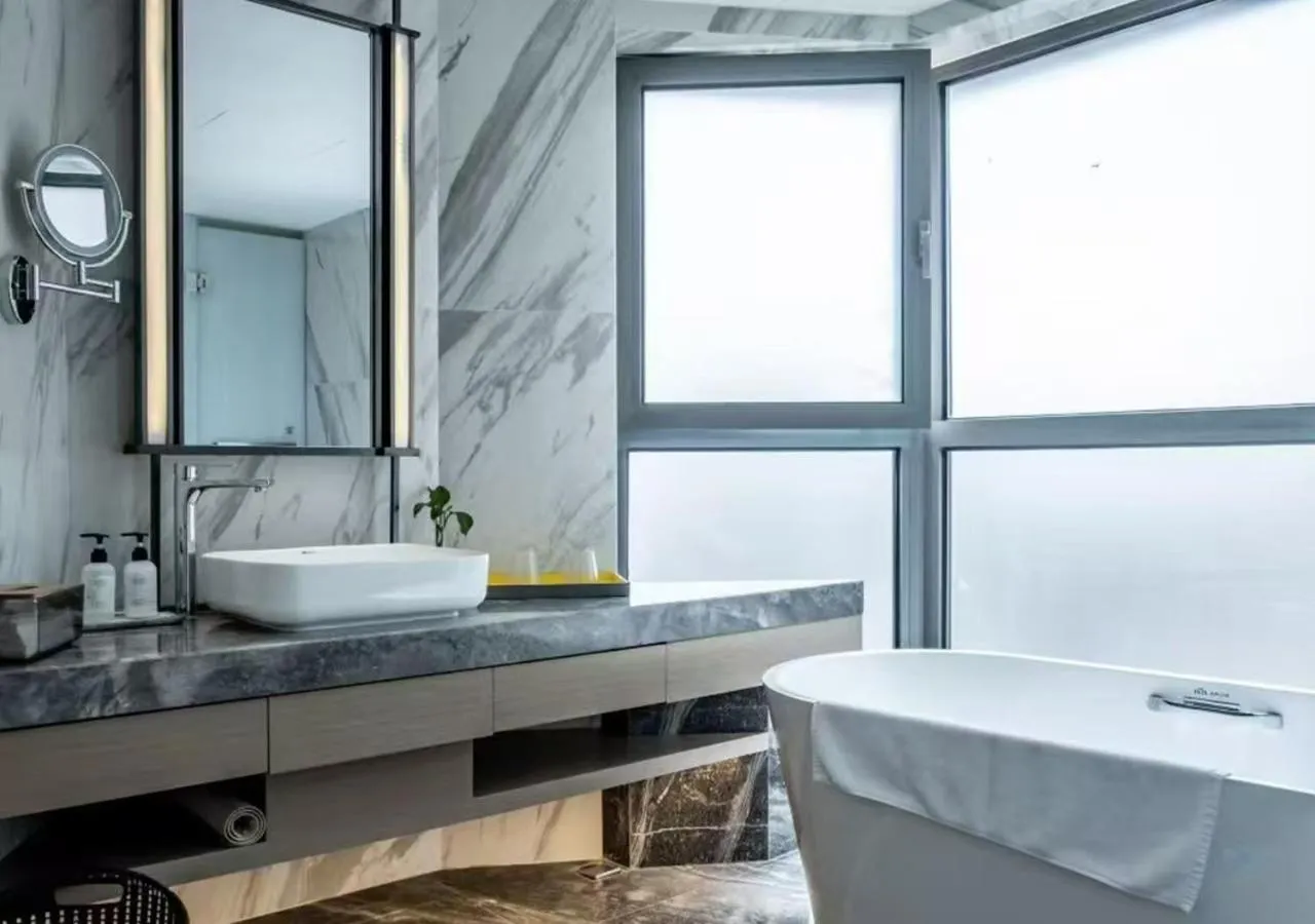 Bathroom in Holiday Inn Shanghai Huaxia by IHG - overlooking city scenery at Sky View Restaurant
