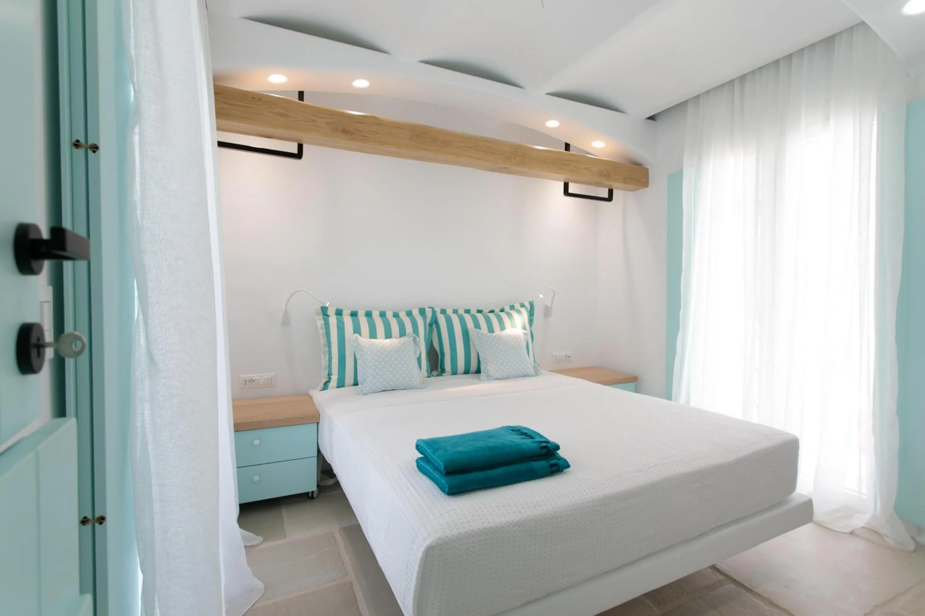 Bed in Majo Suites Hotel