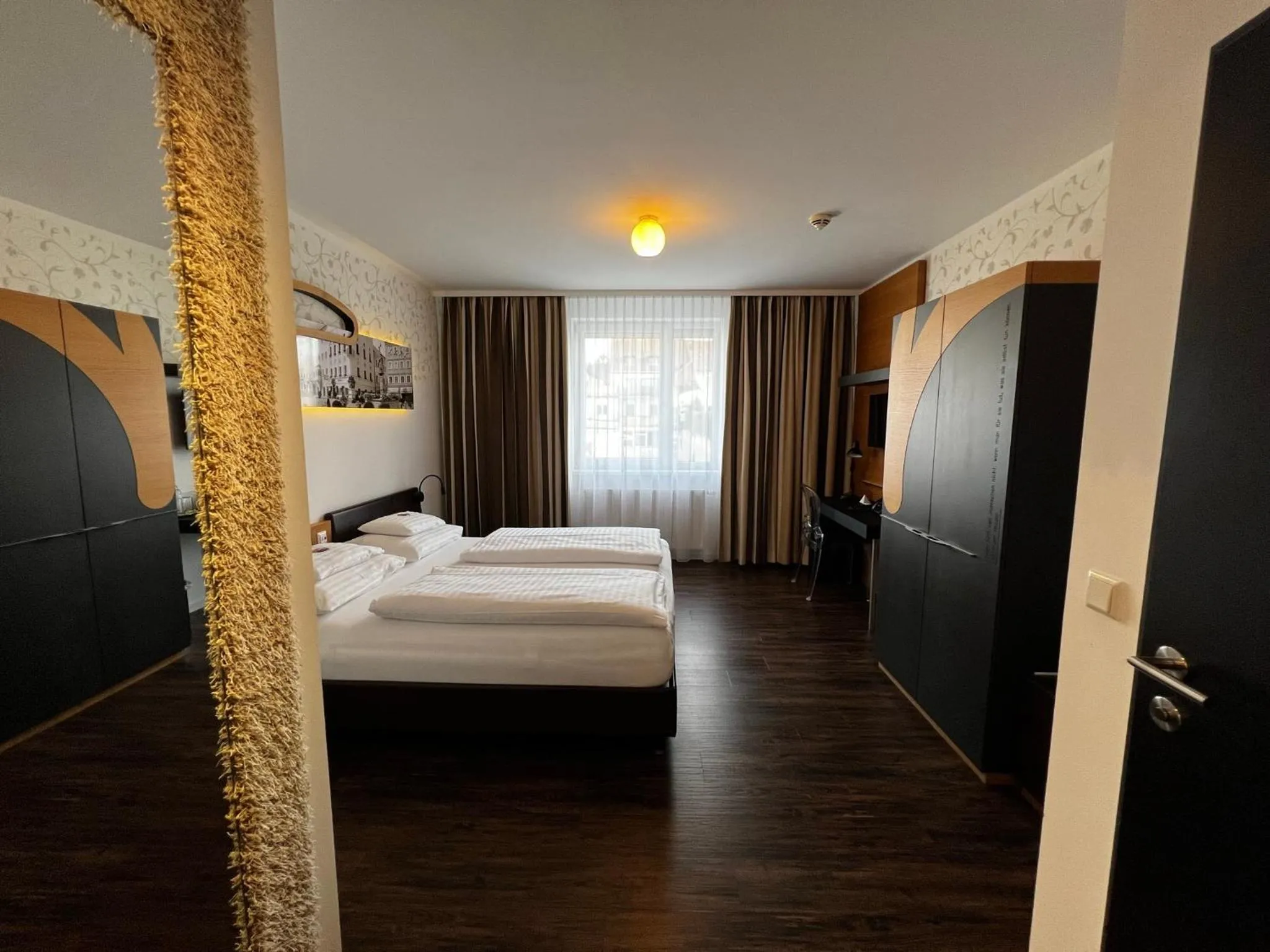 Photo of the whole room, Bed in H+ Hotel Ried