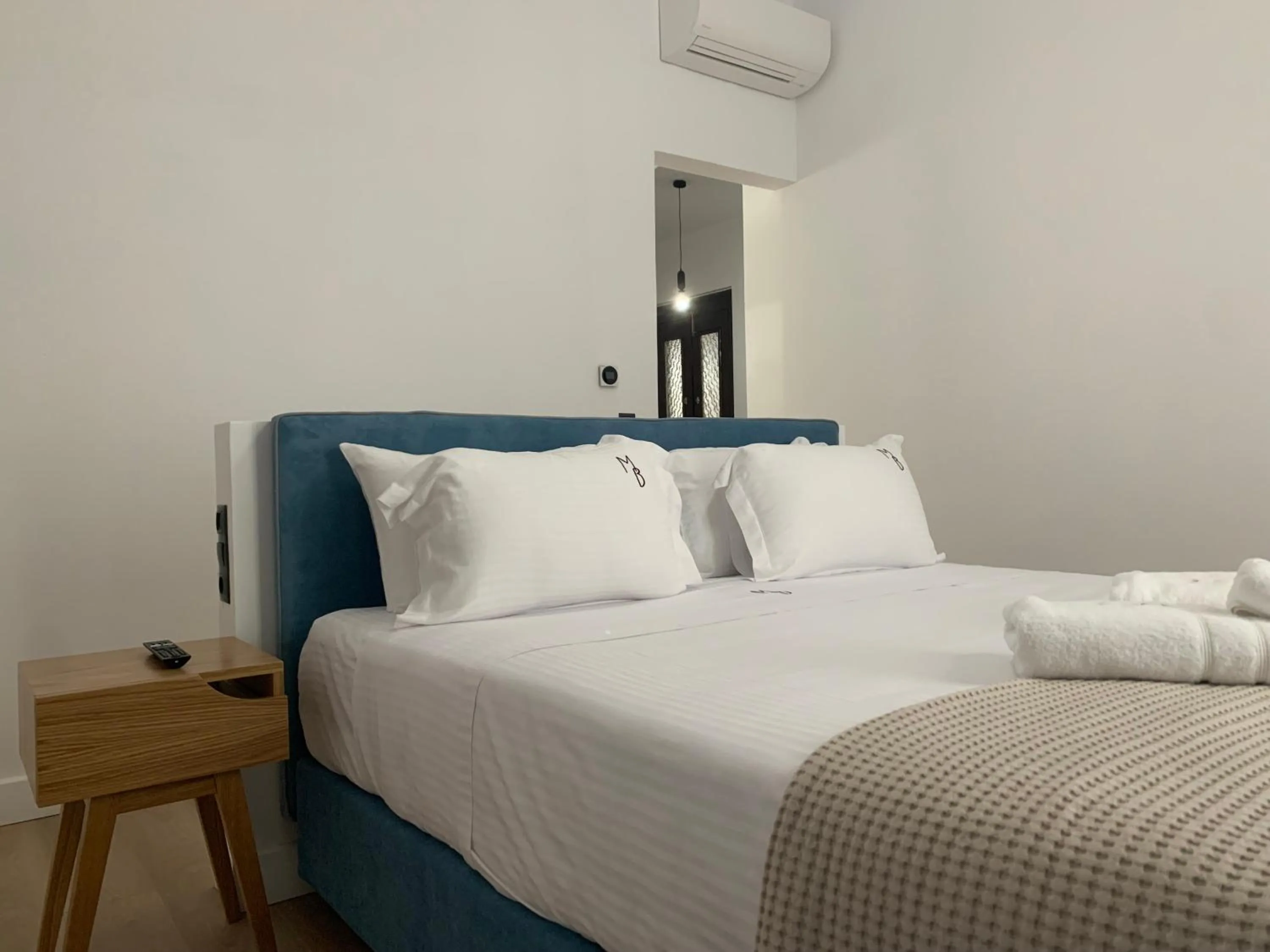 Bed in The Maroon Bottle Luxury Suites