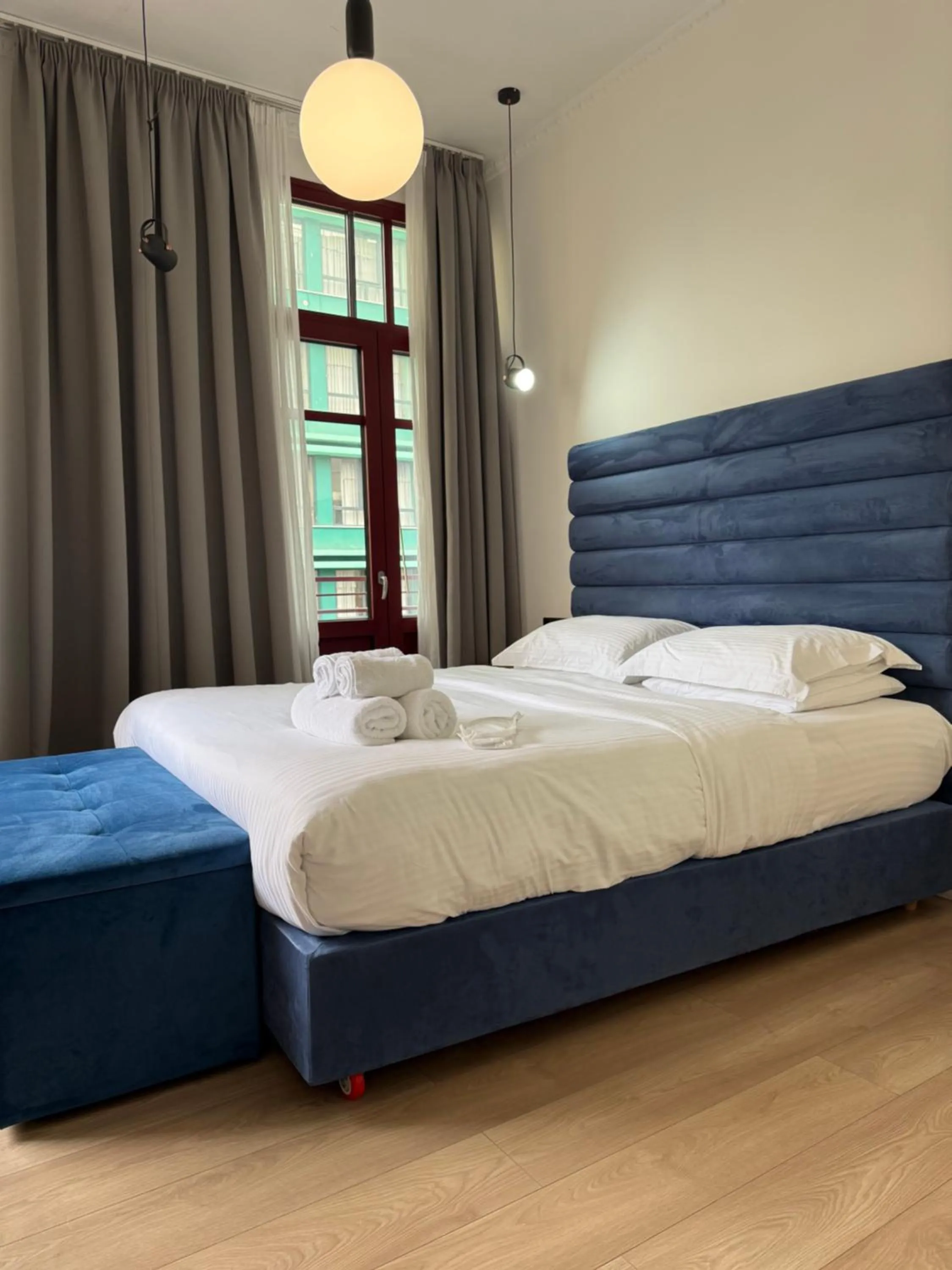 Bed in The Maroon Bottle Luxury Suites