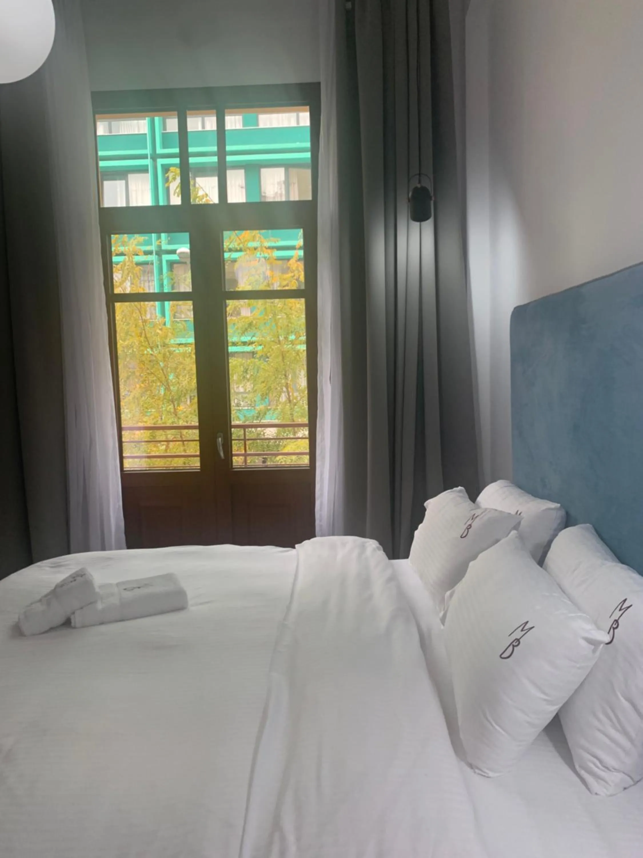 Bed in The Maroon Bottle Luxury Suites