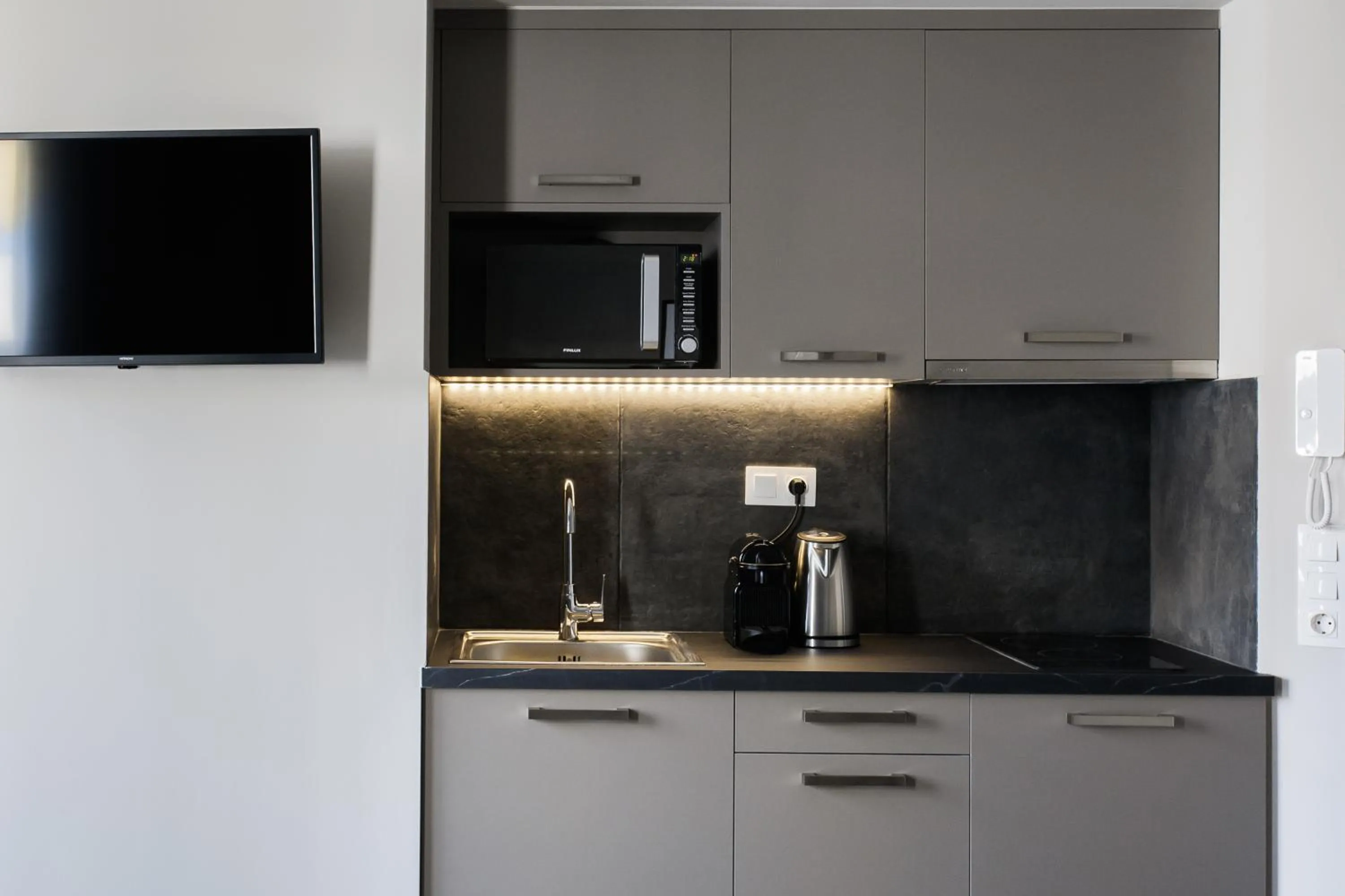 TV and multimedia in WYZ Athens Apartments by UPSTREET