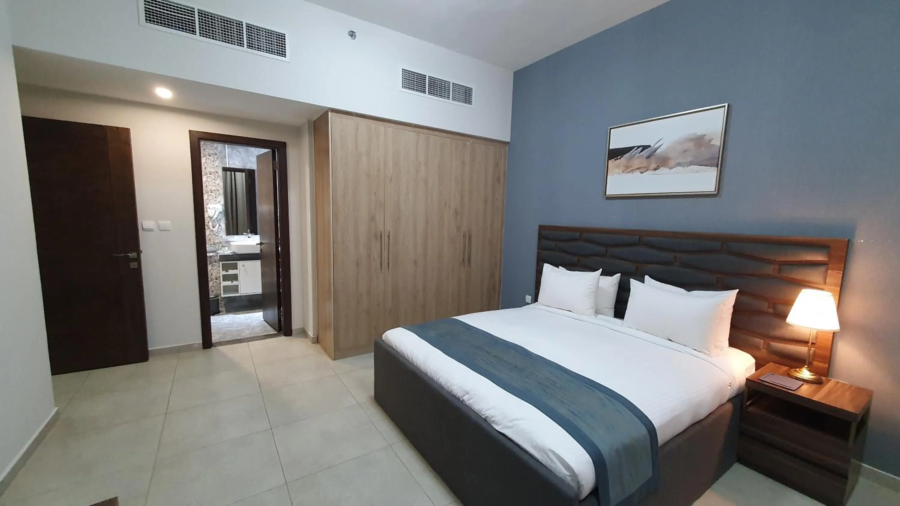 Bed in Luxe Grand Hotel Apartments