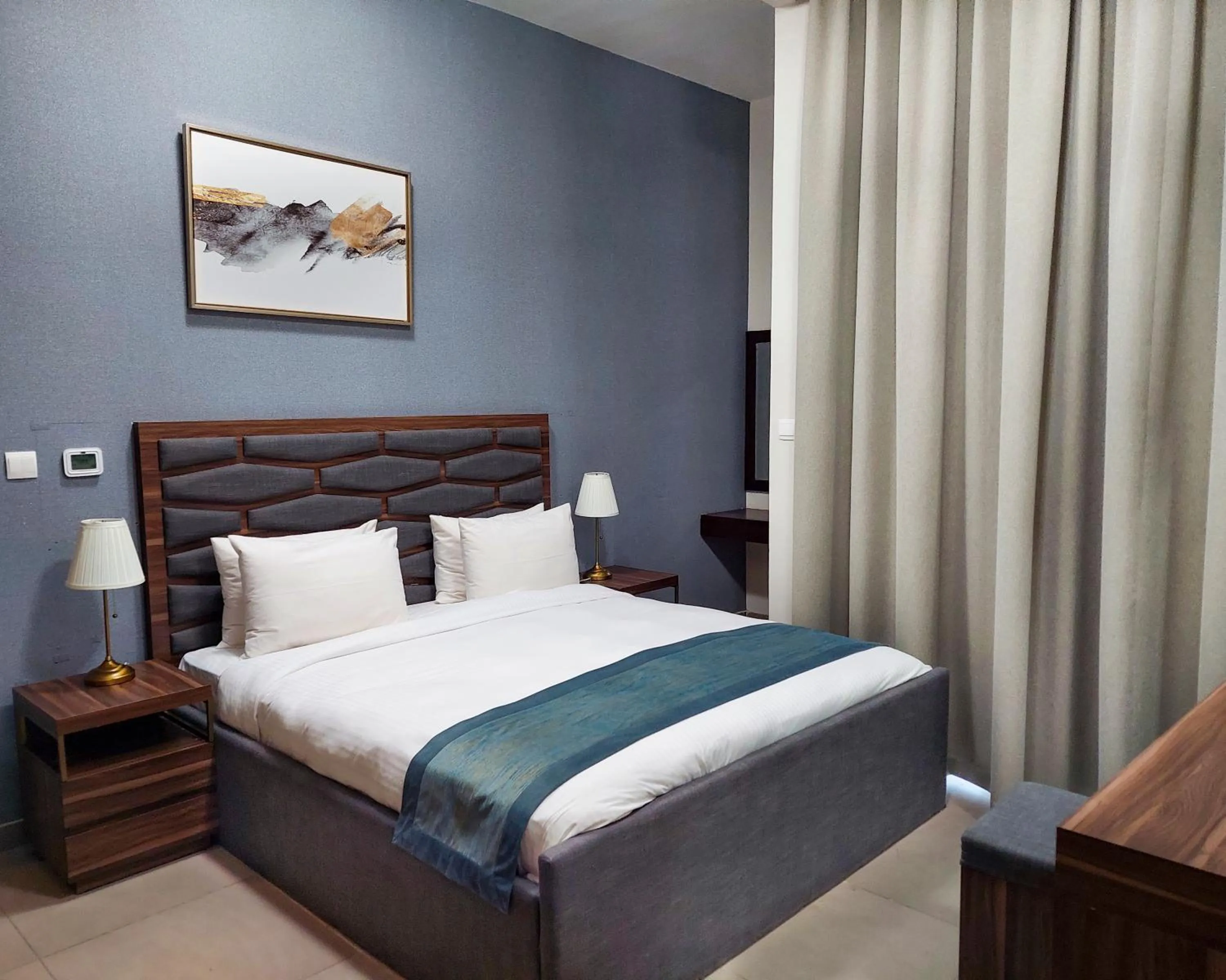 Bed in Luxe Grand Hotel Apartments