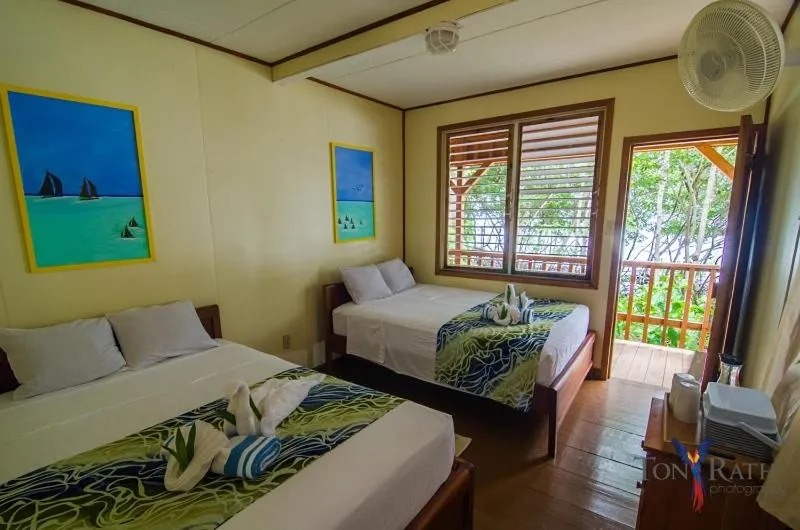 Bedroom, Bed in Pelican Beach Resort South Water Caye
