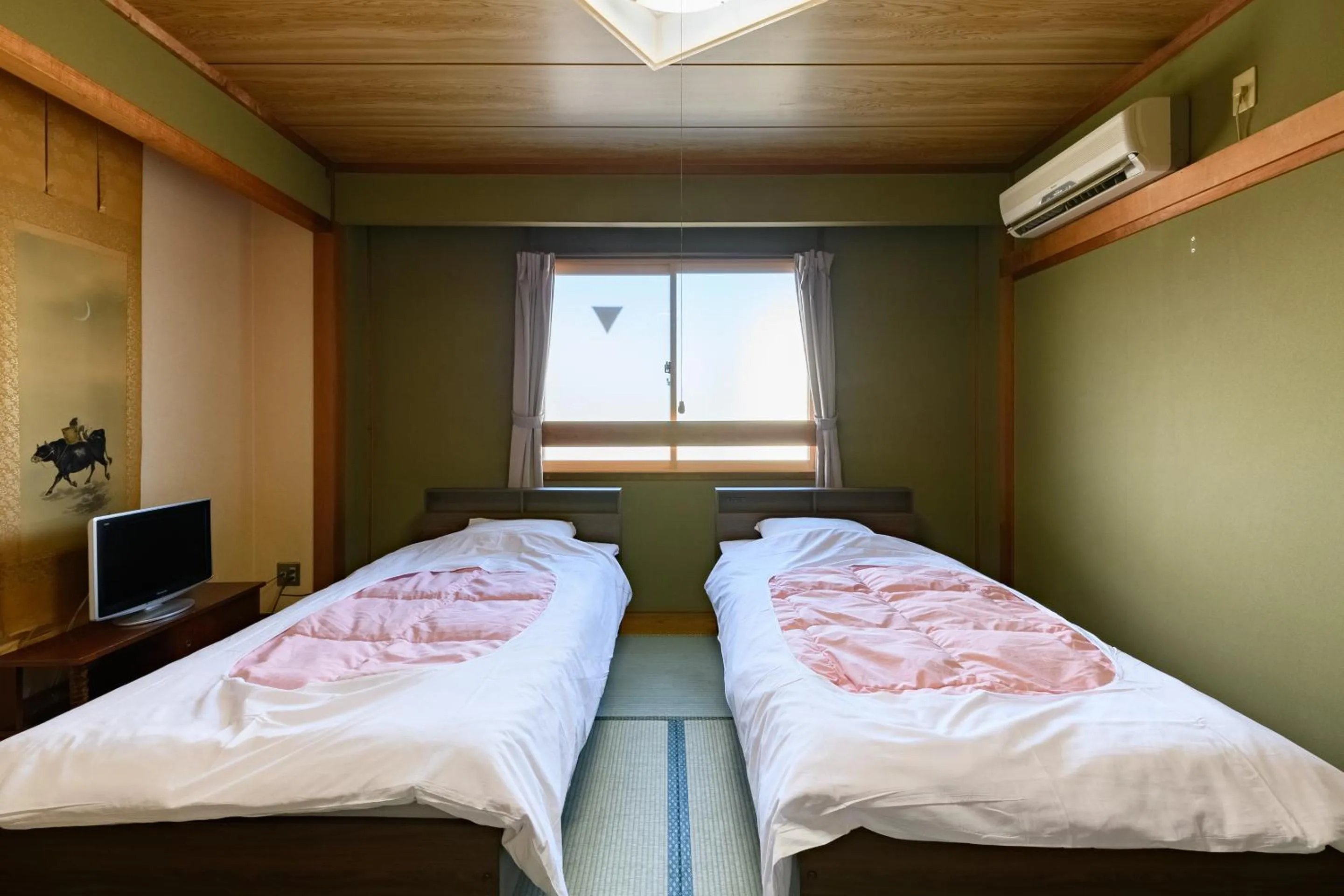 Bed in Tabist HotelNakajima Fuji