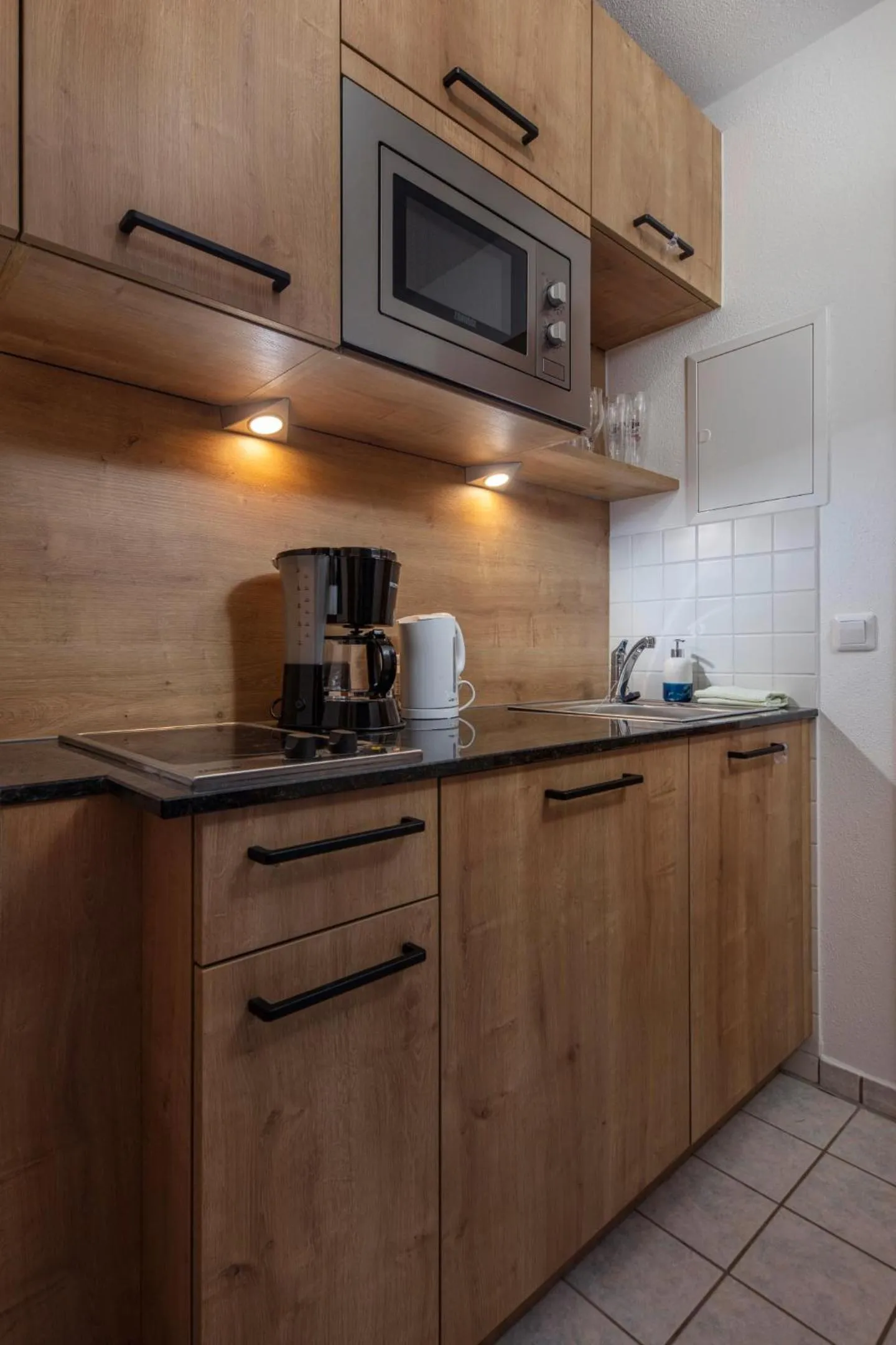 Kitchen or kitchenette in Aparthotel Chiemgaufuchs - CHIEMGAUKARTE