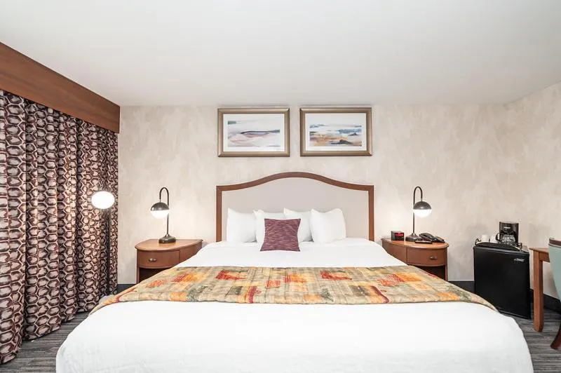 Bed in Bellissimo Hotel, Trademark by Wyndham Near Foxwoods Casino