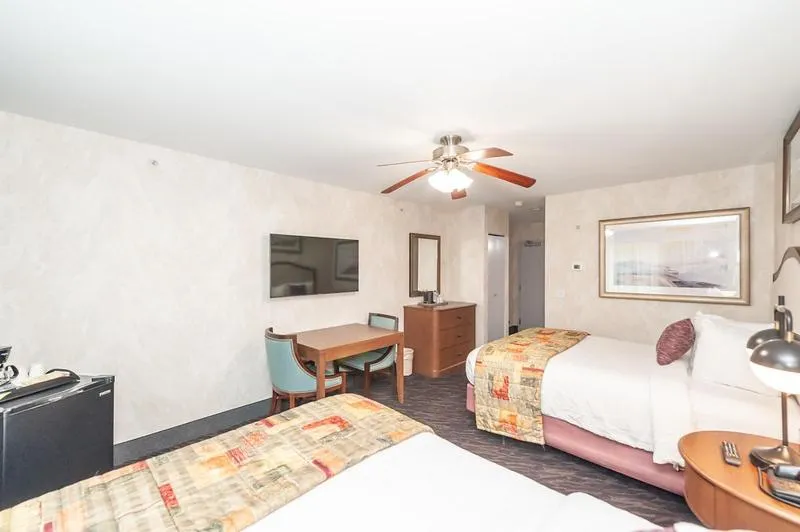 Bed in Bellissimo Hotel, Trademark by Wyndham Near Foxwoods Casino