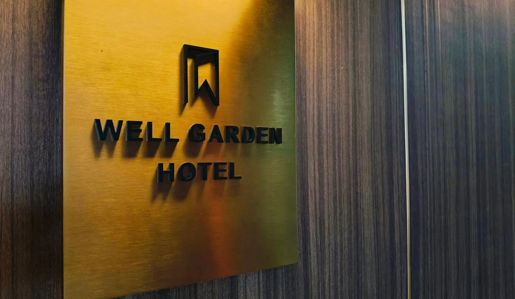 Property logo or sign in Well Garden Hotel