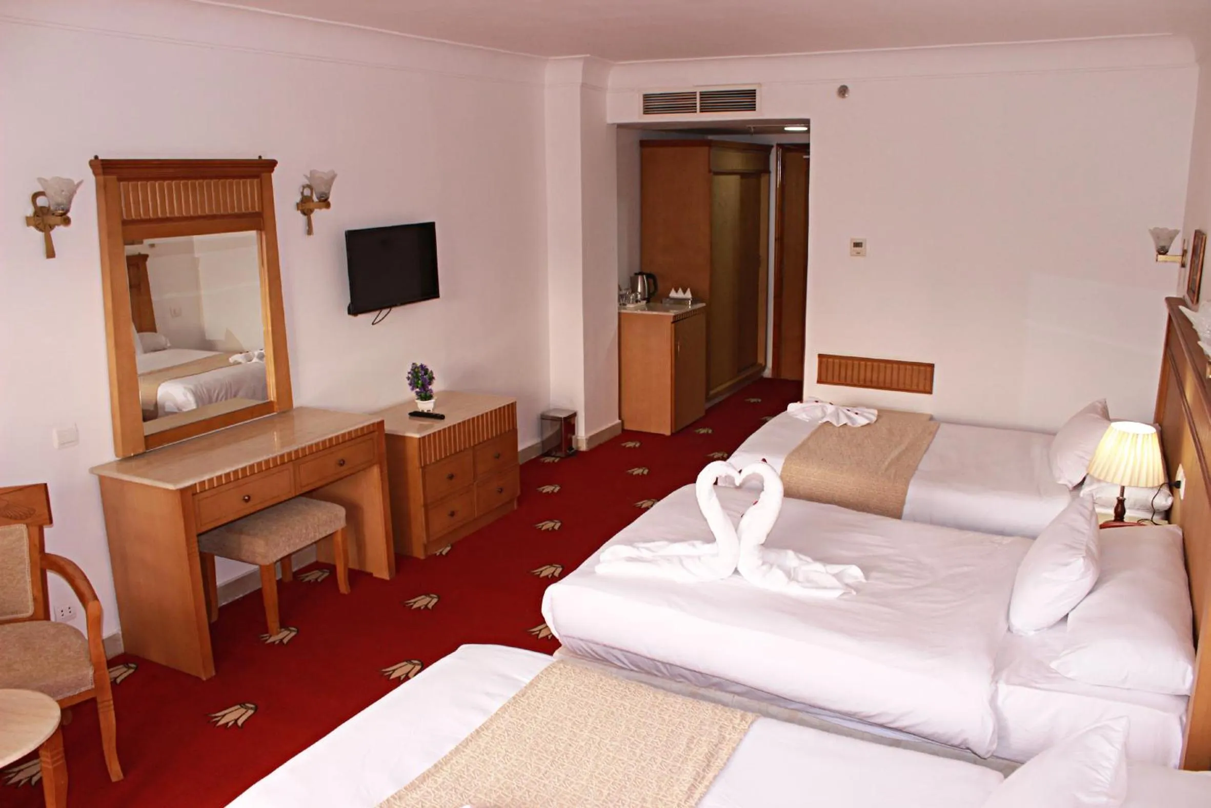 Communal lounge/ TV room, Bed in Regency Pyramids Hotel