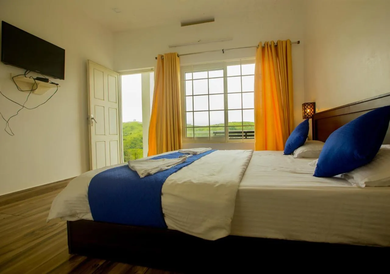 Bed in White Stone Vagamon Hilltop Cottage by VOYE HOMES