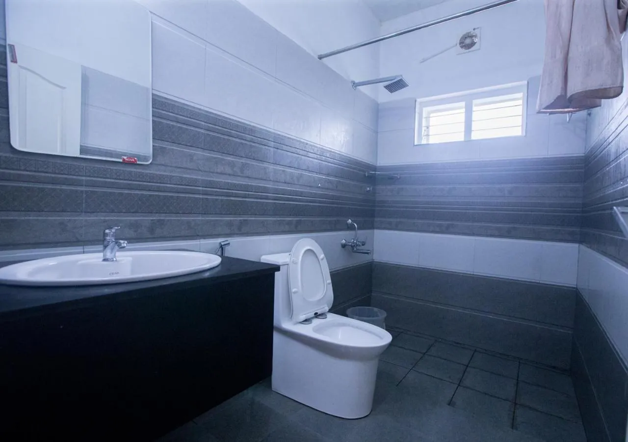 Shower in White Stone Vagamon Hilltop Cottage by VOYE HOMES