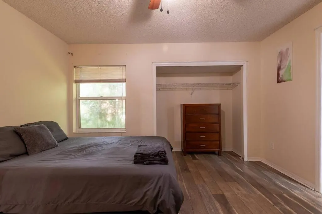 Bed in Tropical Escape with Relaxing Heated Pool & Palm Breezes