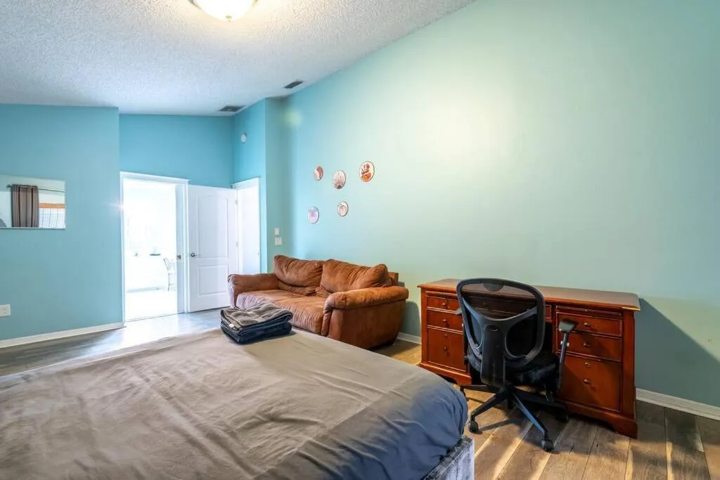 Bed in Tropical Escape with Relaxing Heated Pool & Palm Breezes