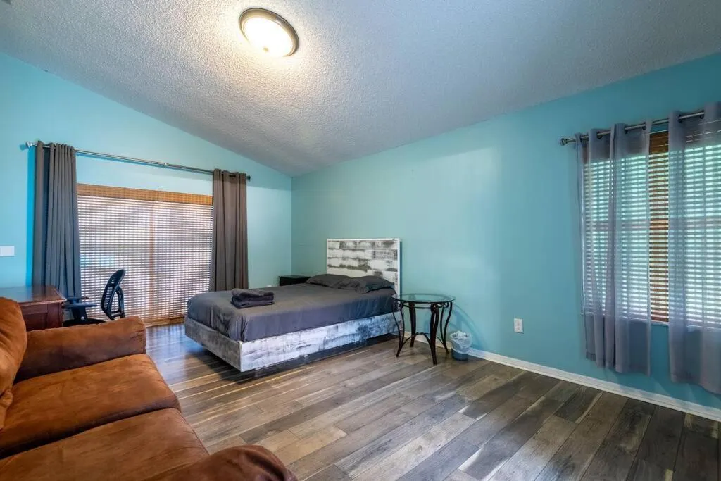 Bed in Tropical Escape with Relaxing Heated Pool & Palm Breezes