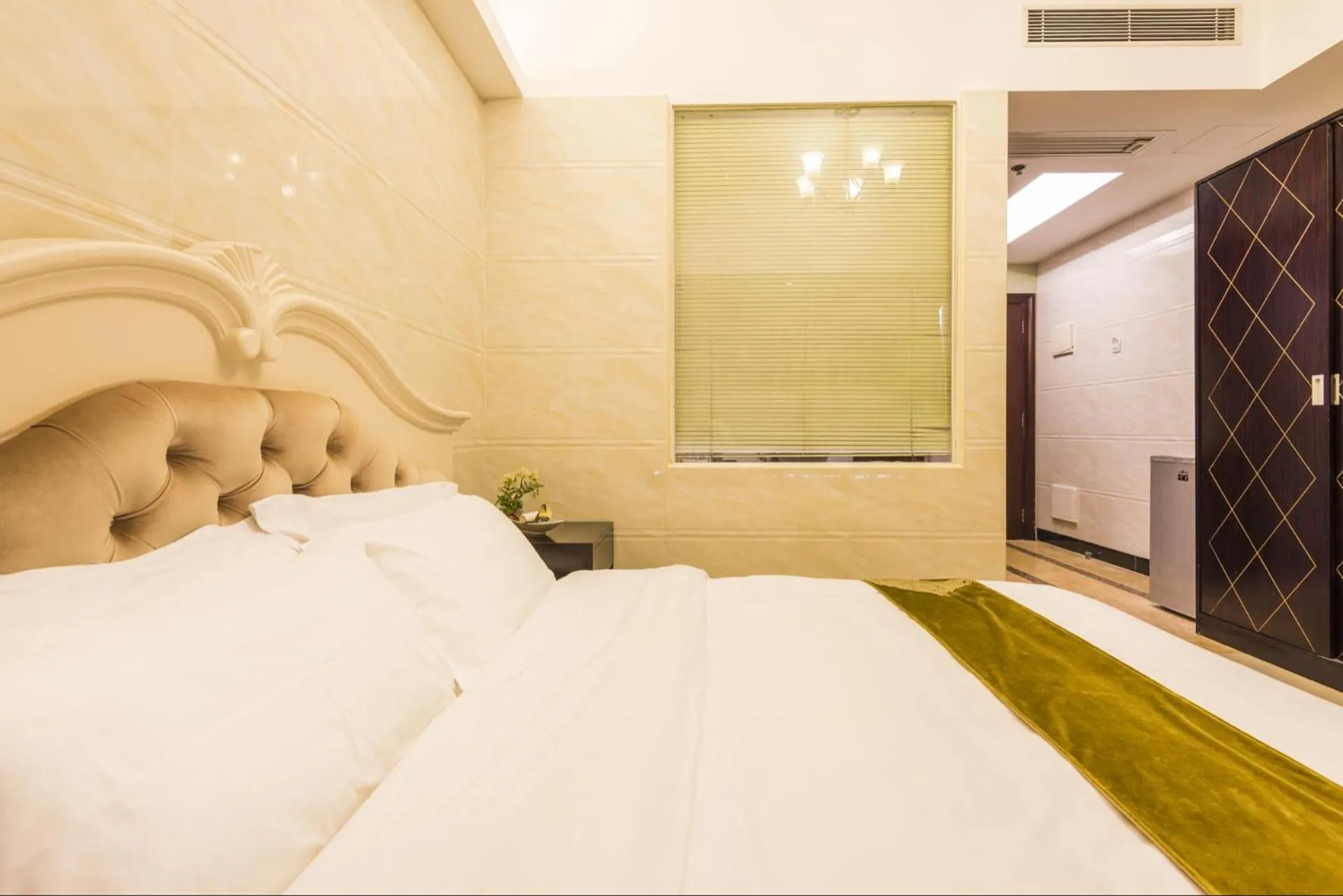 Bed in Grand Continental Apartment