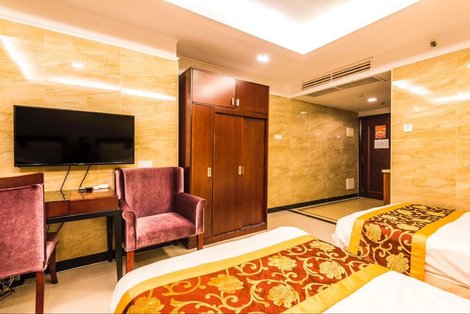 Bed in Grand Continental Apartment