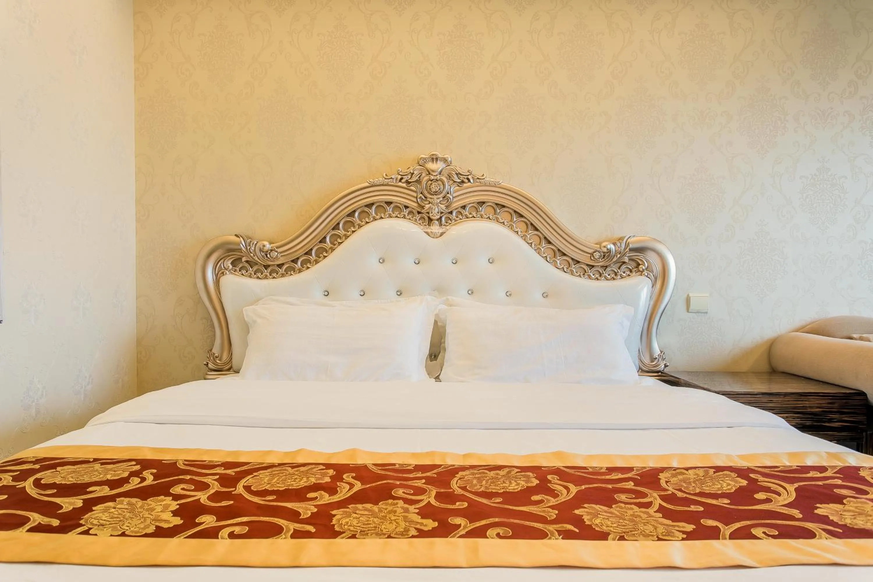 Bed in Grand Continental Apartment