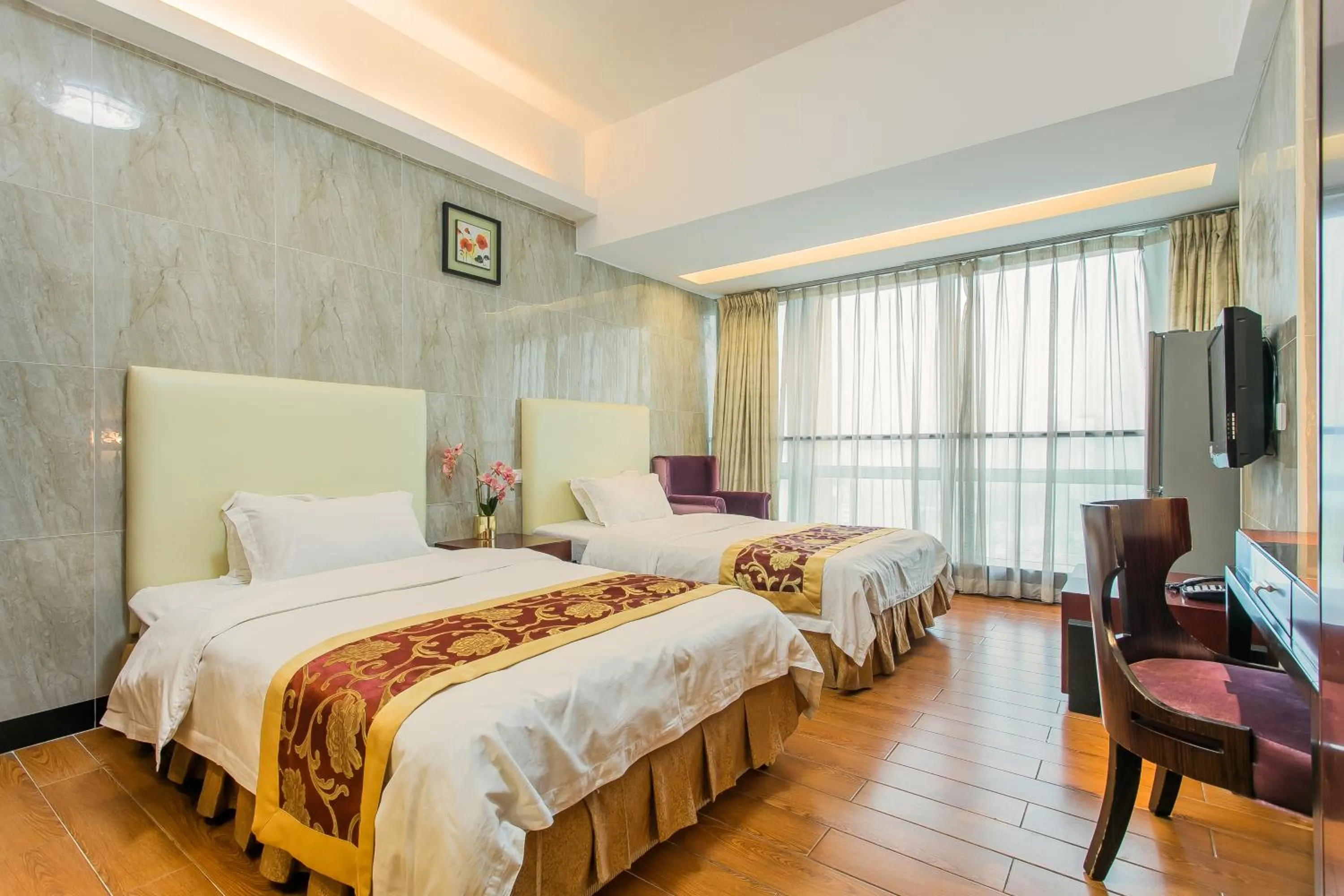 Bed in Grand Continental Apartment