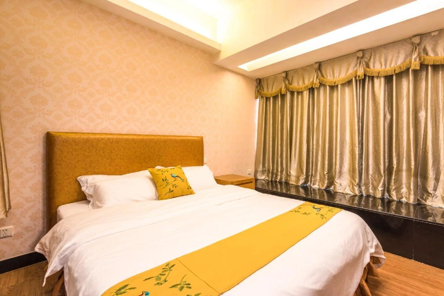 Bed in Grand Continental Apartment