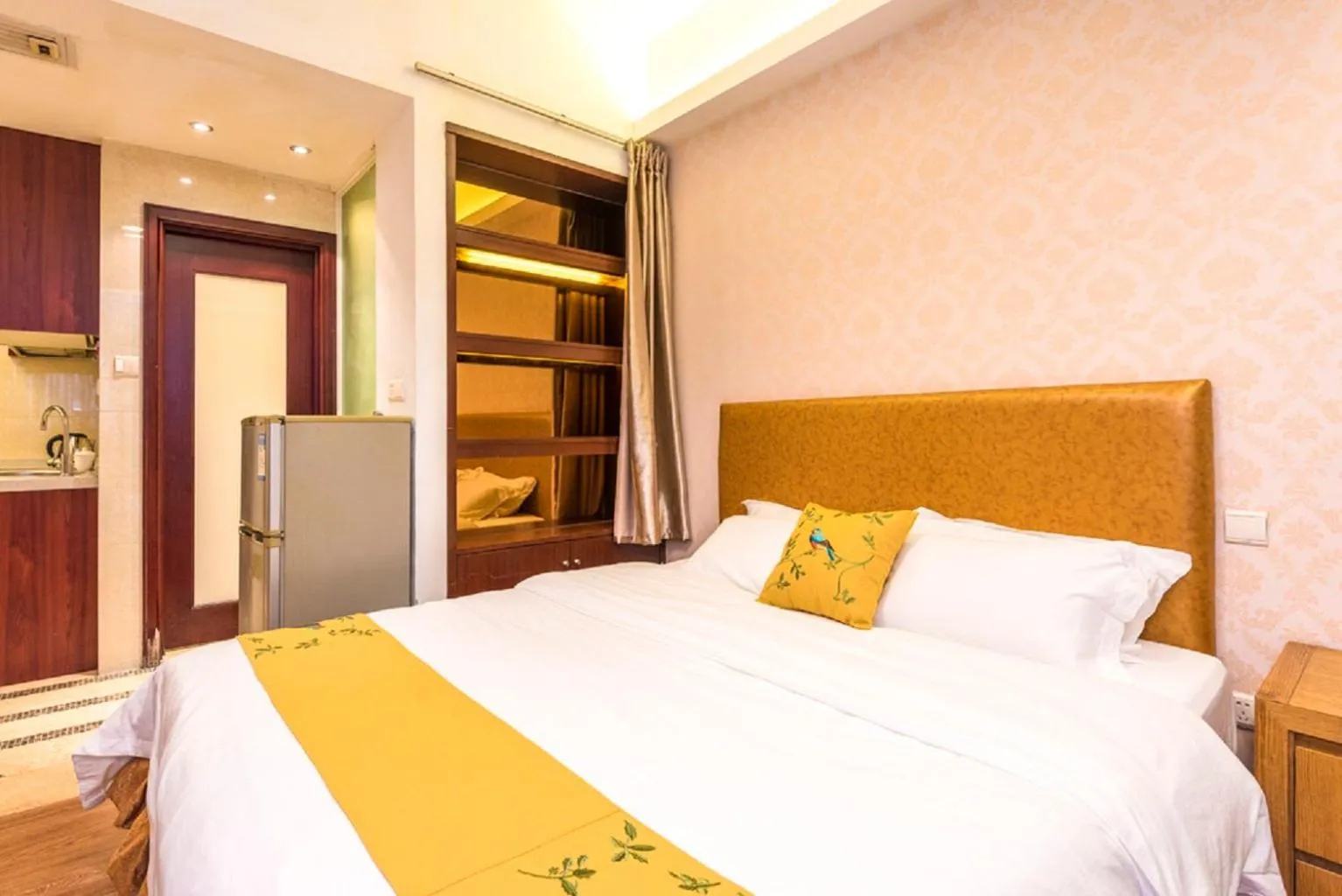 Bed in Grand Continental Apartment