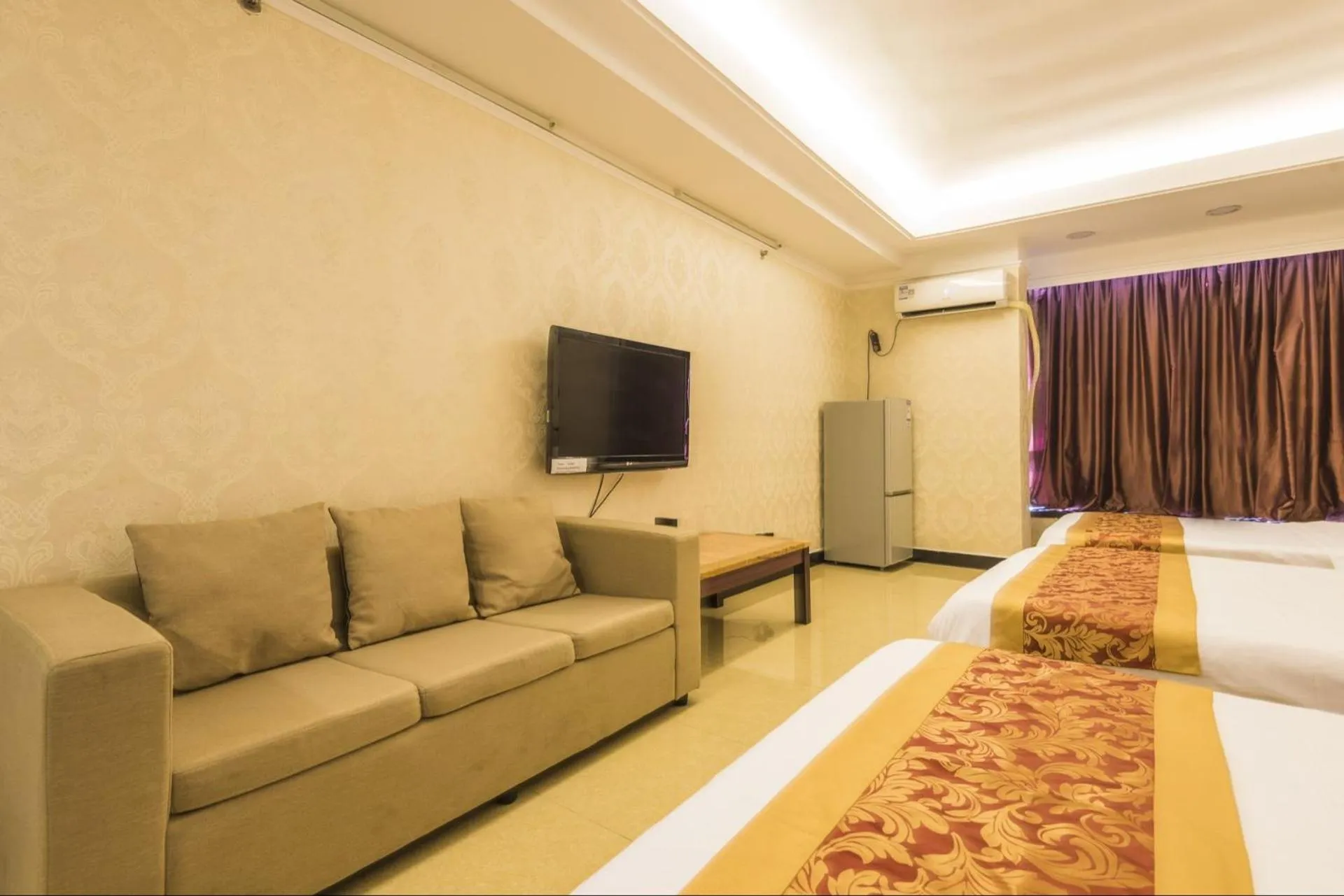 Bed in Grand Continental Apartment