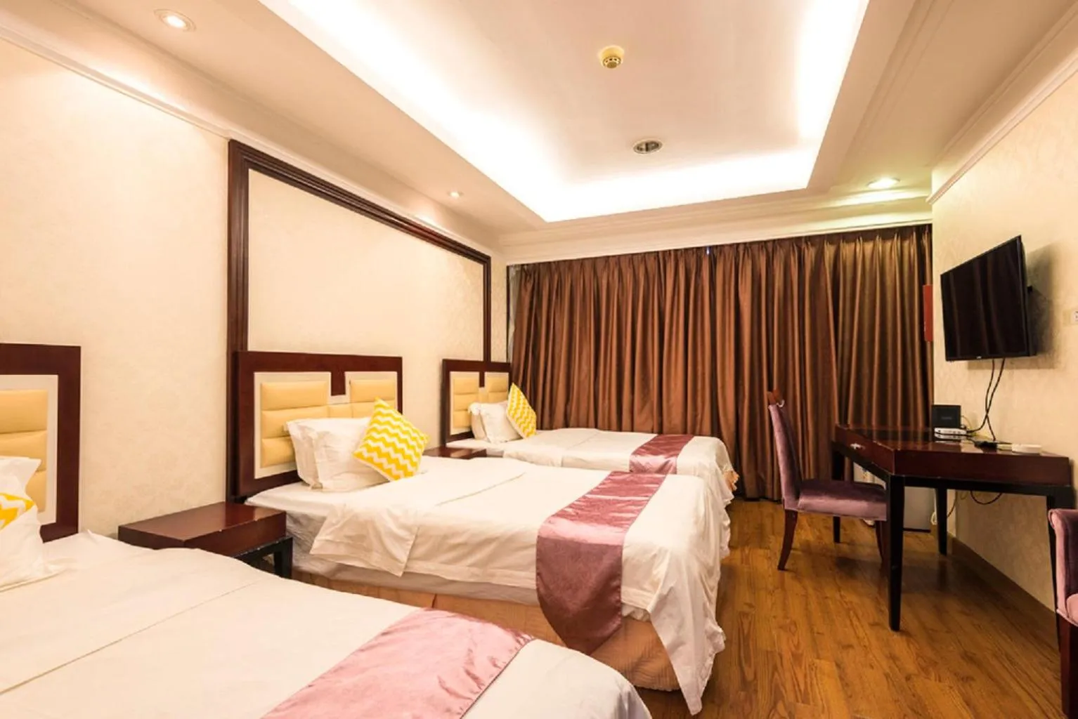 Bed in Grand Continental Apartment