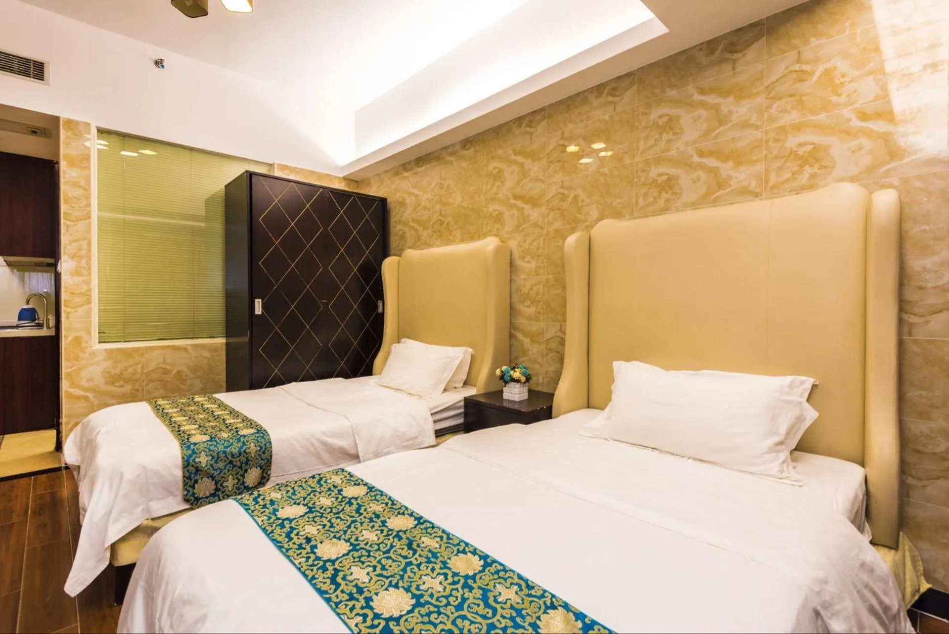 Bed in Grand Continental Apartment