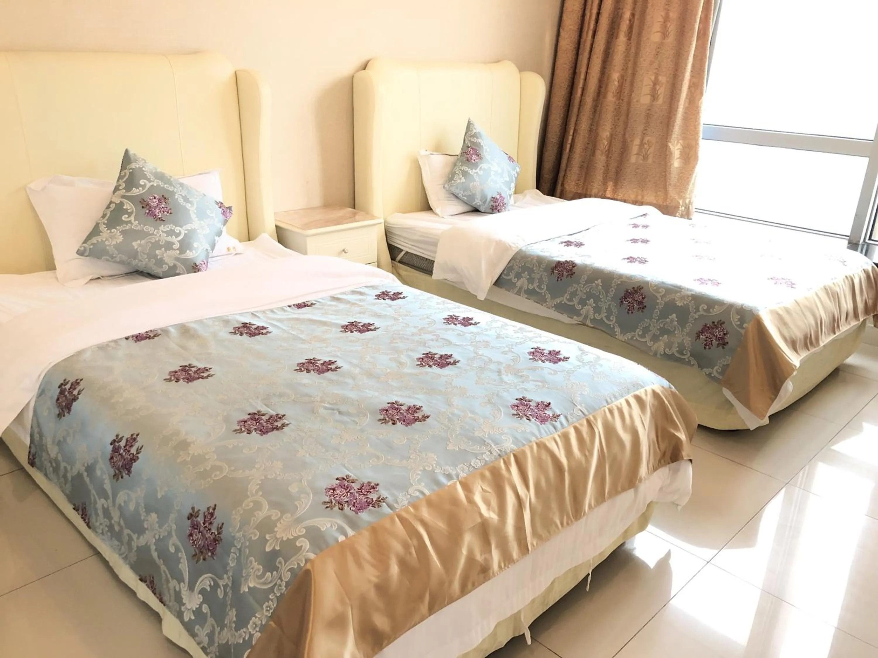 Bed in Grand Continental Apartment