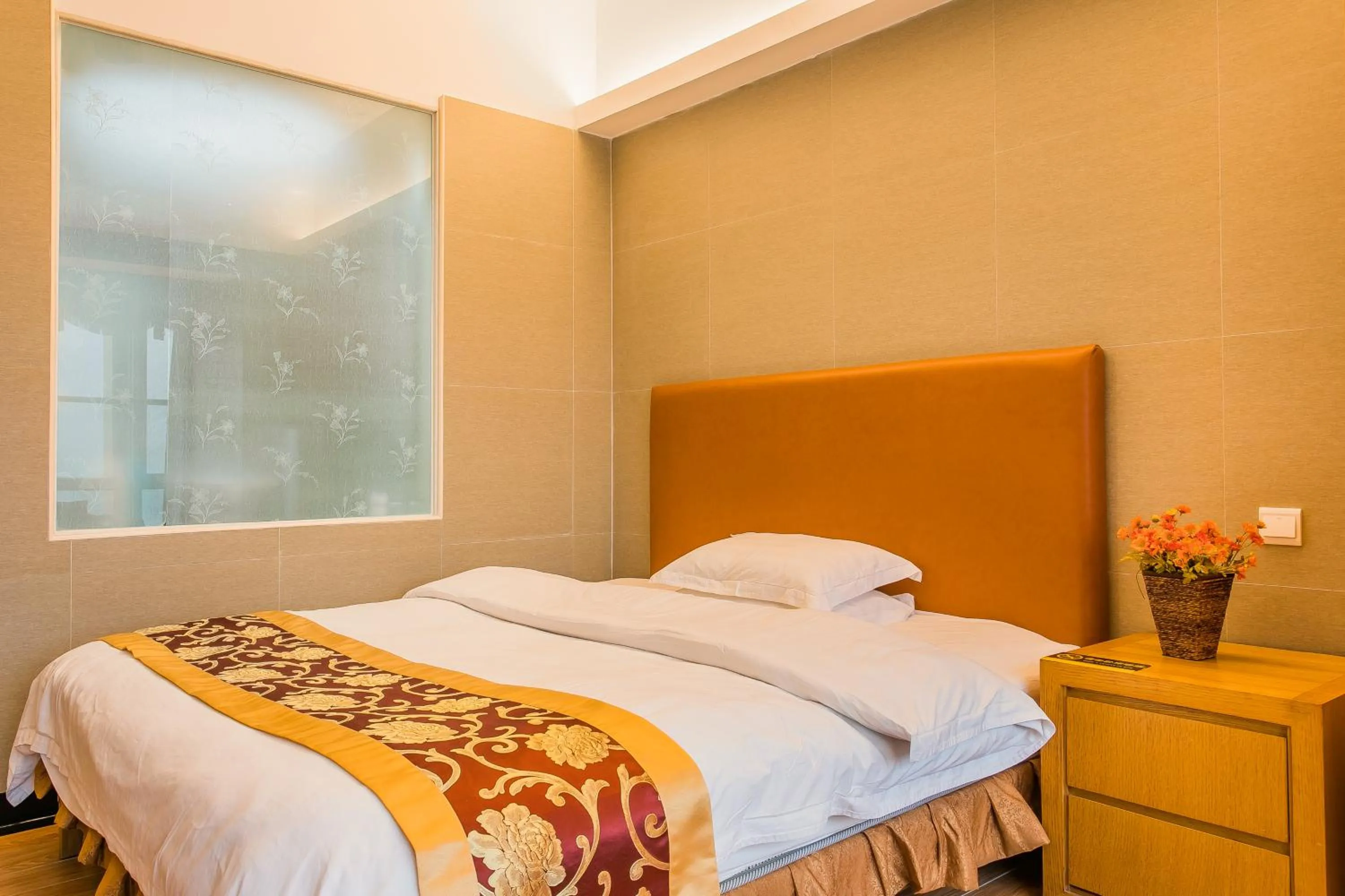 Bed in Grand Continental Apartment