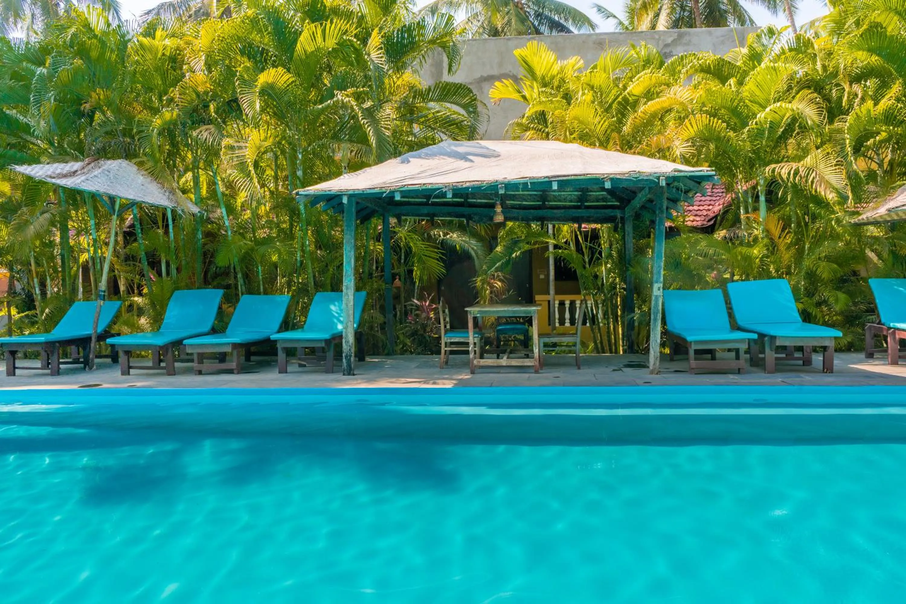 Swimming pool in juSTa Morjim Beach Resort Goa - 80 Steps from Morjim Beach