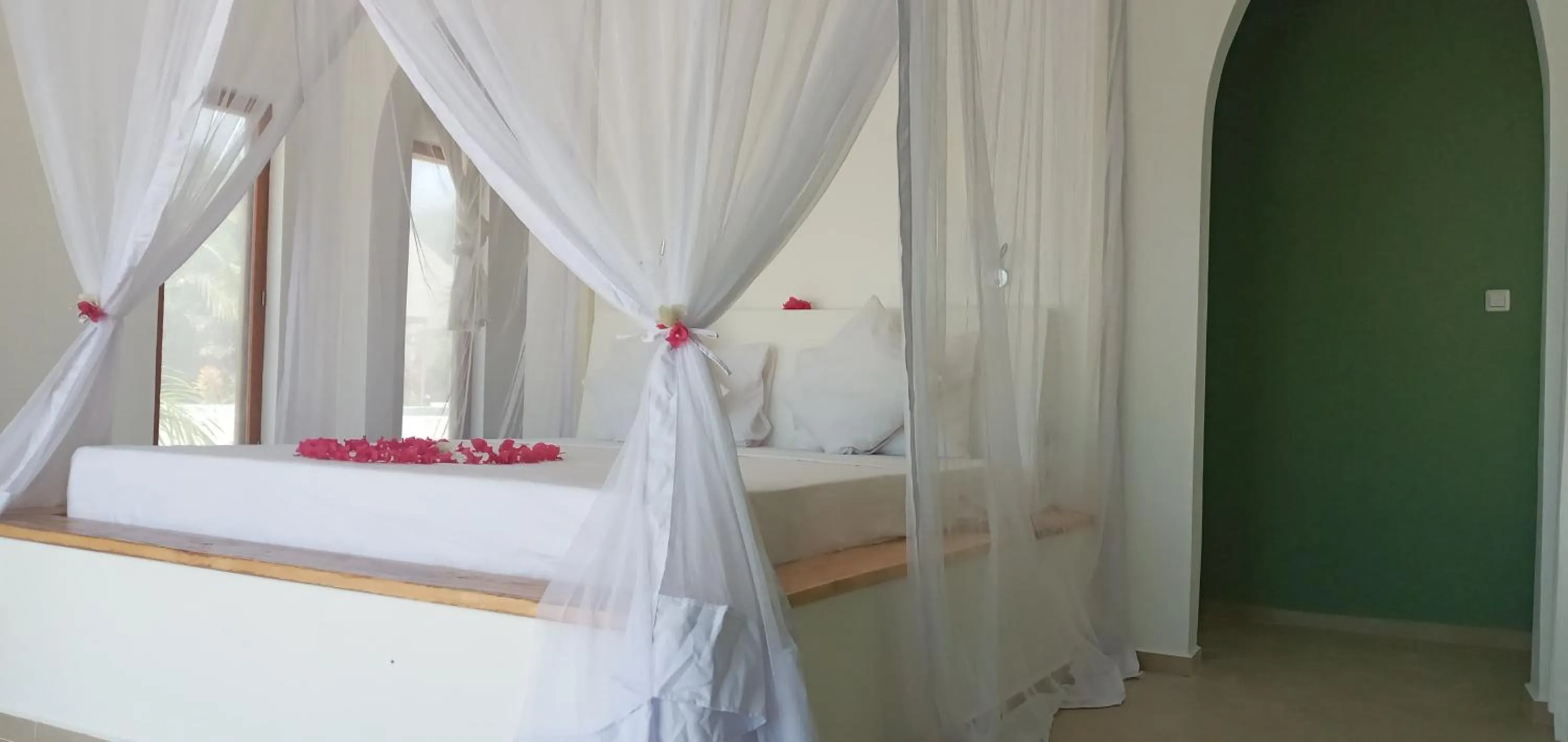 Bed in Kijani Beach Villas