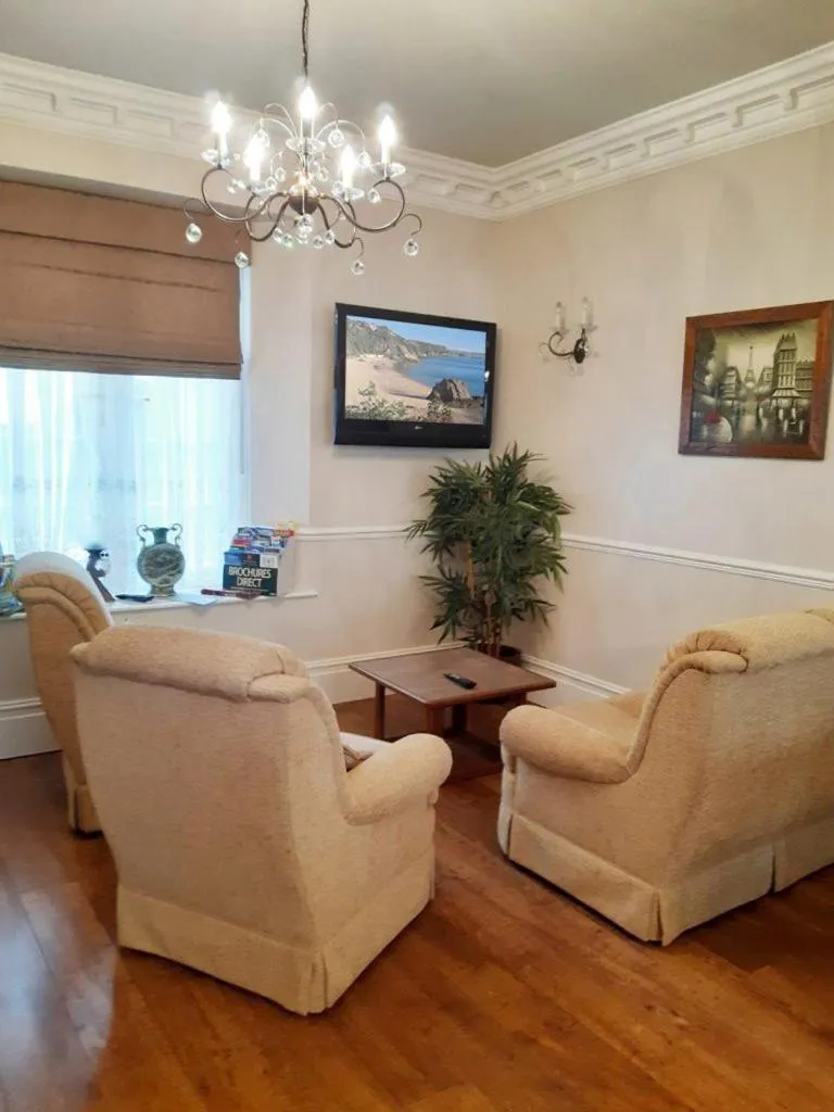 Communal lounge/ TV room in Hildebrand Guest House