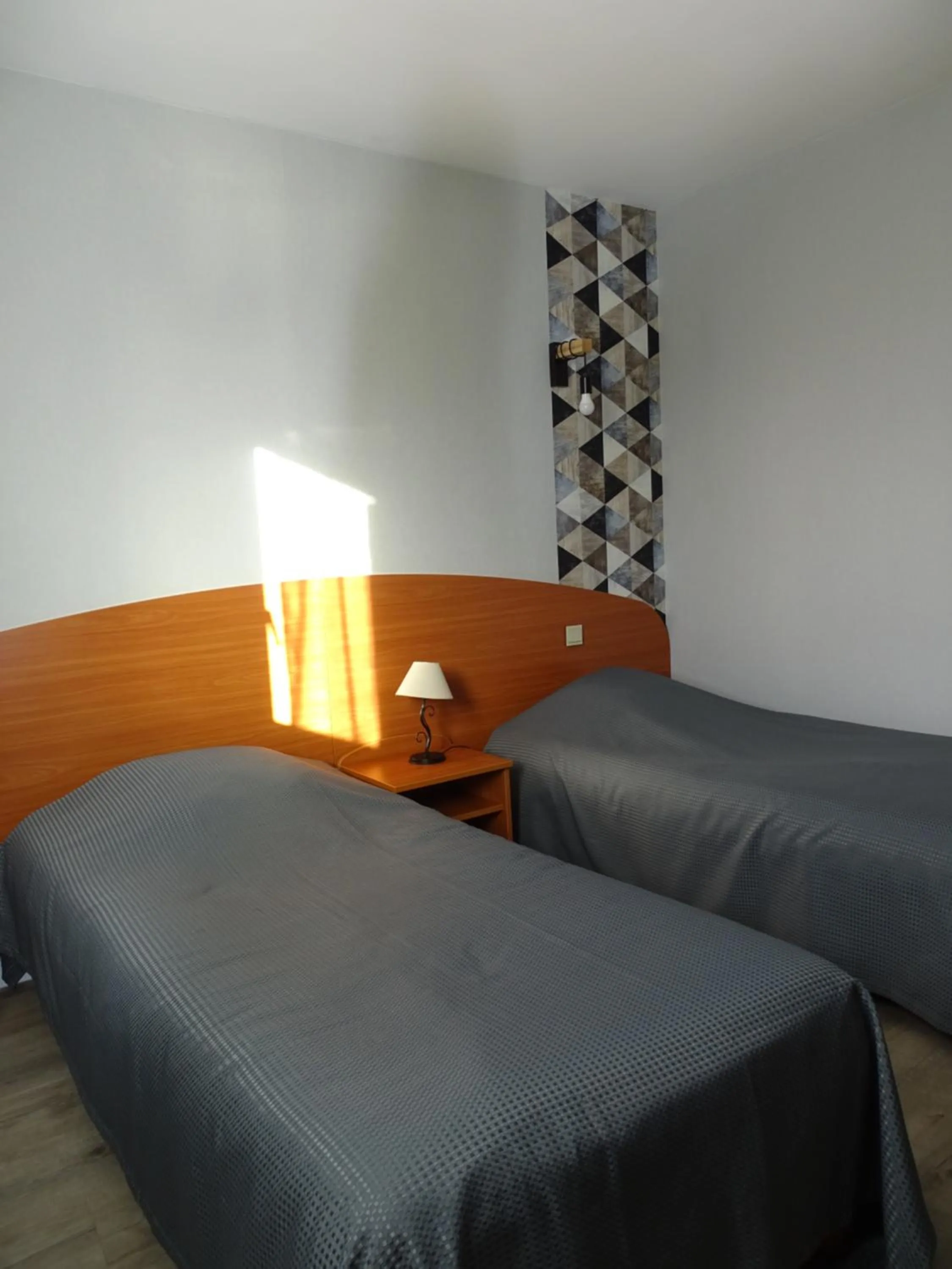 Bed in LOGIS Hôtel LES 3 MARCHANDS