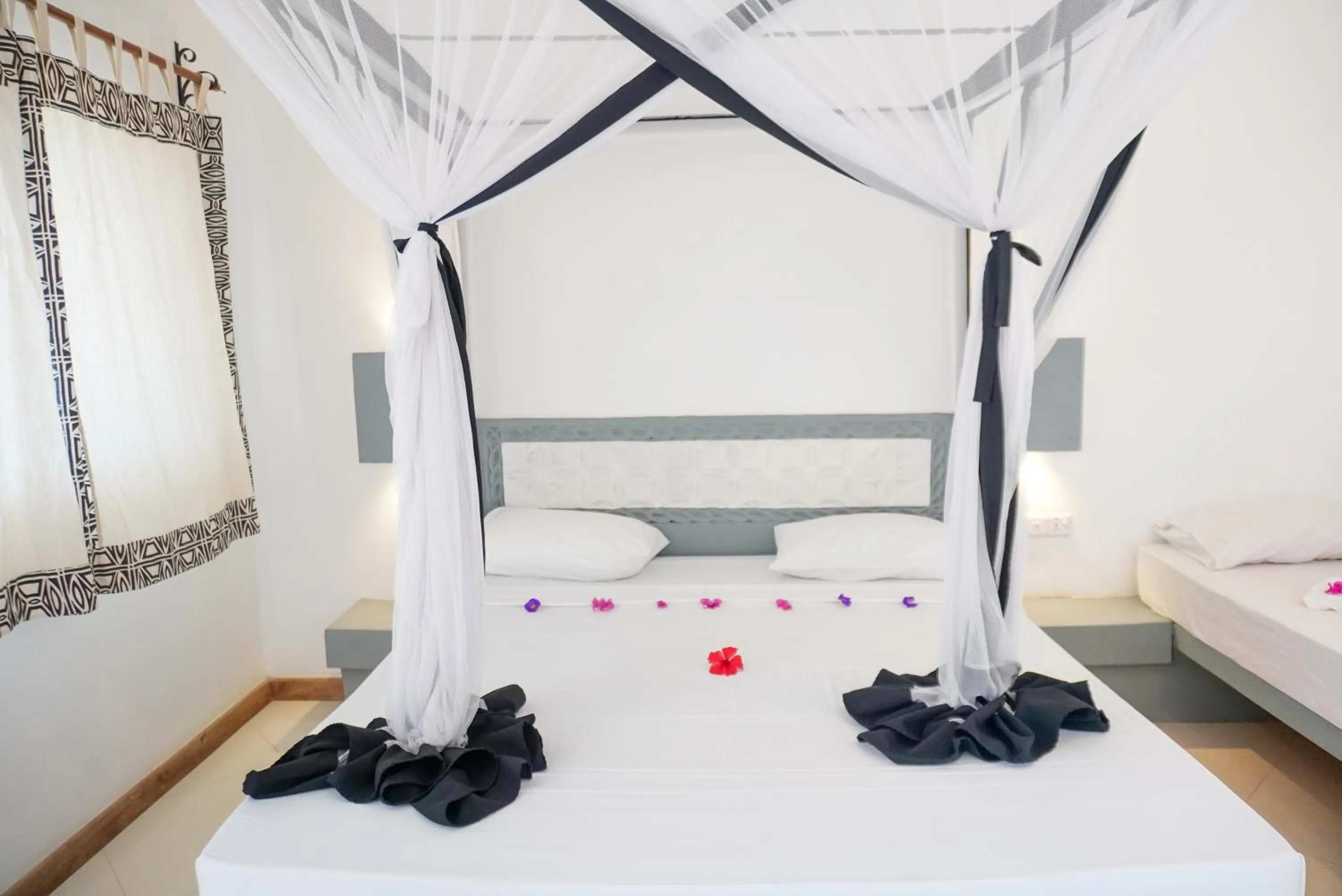 Bed in AHG Sun Bay Mlilile Beach Hotel