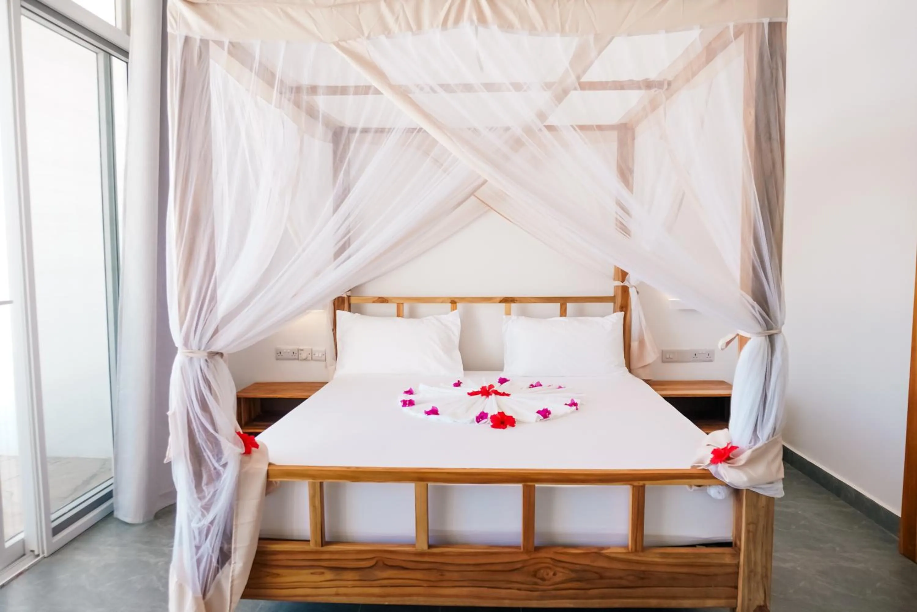 Bed in AHG Sun Bay Mlilile Beach Hotel