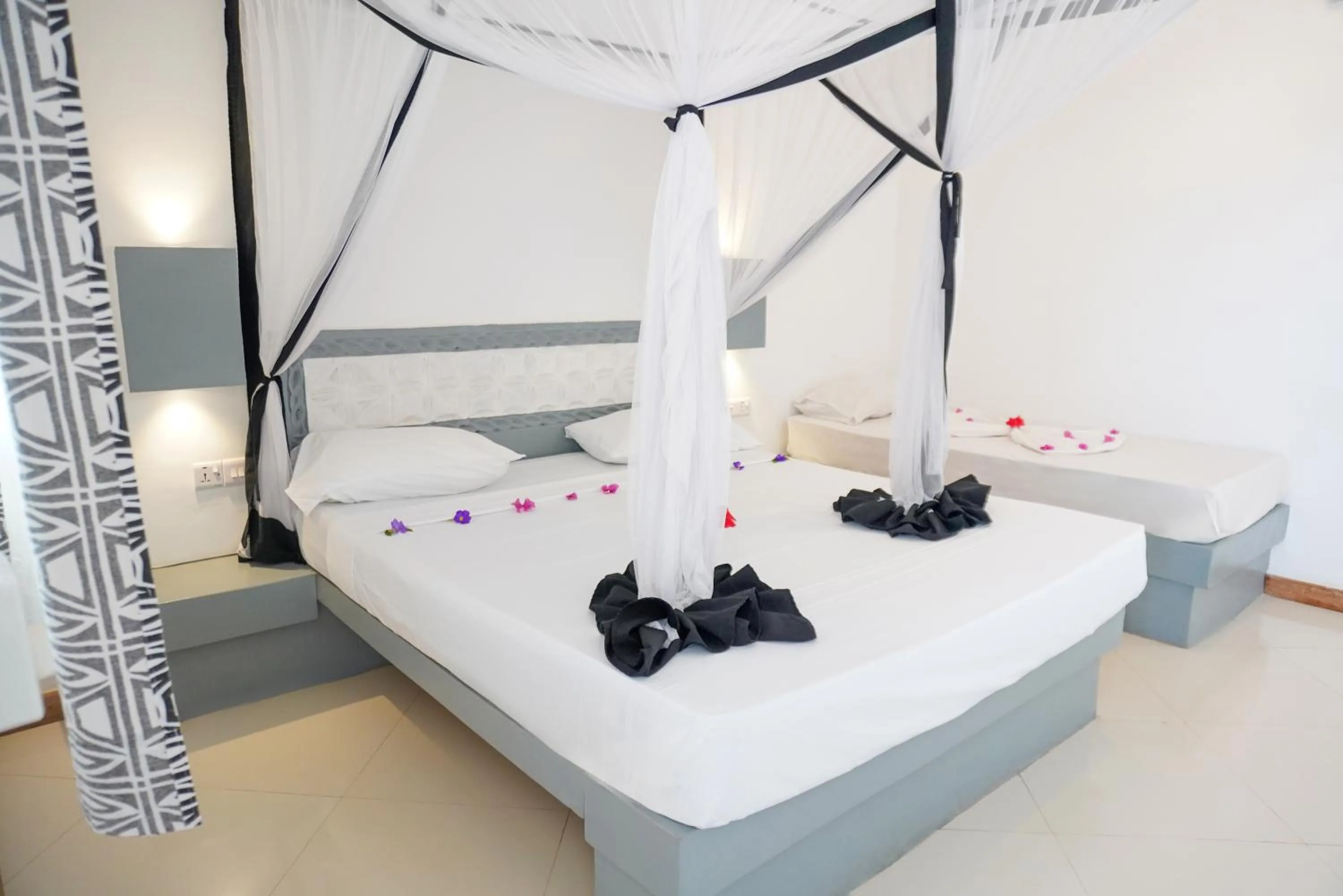 Bed in AHG Sun Bay Mlilile Beach Hotel