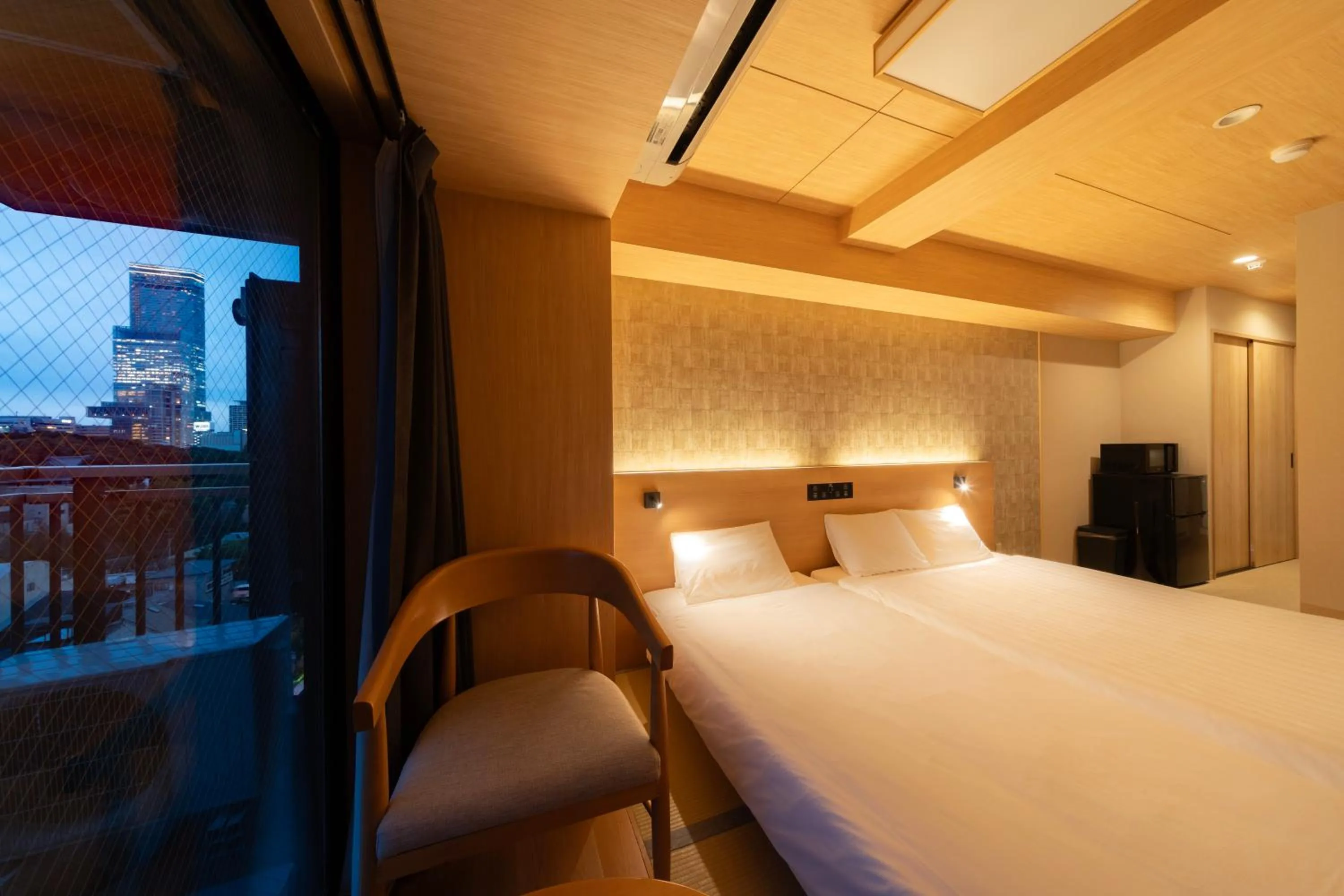 Bed in WELLSTAY Shinsekai Wakyo