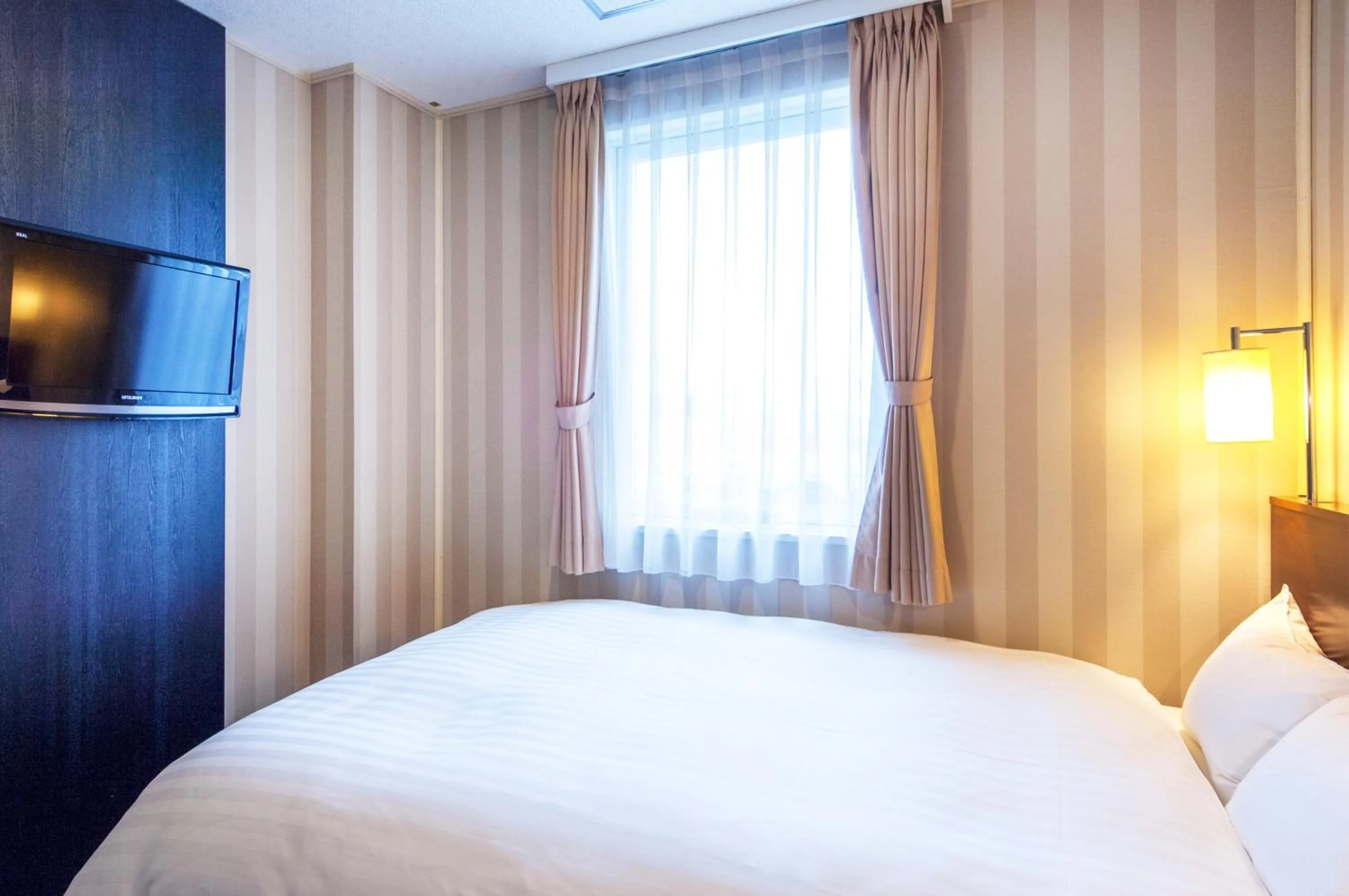 Bed in TsukubaNoYu Urban Hotel