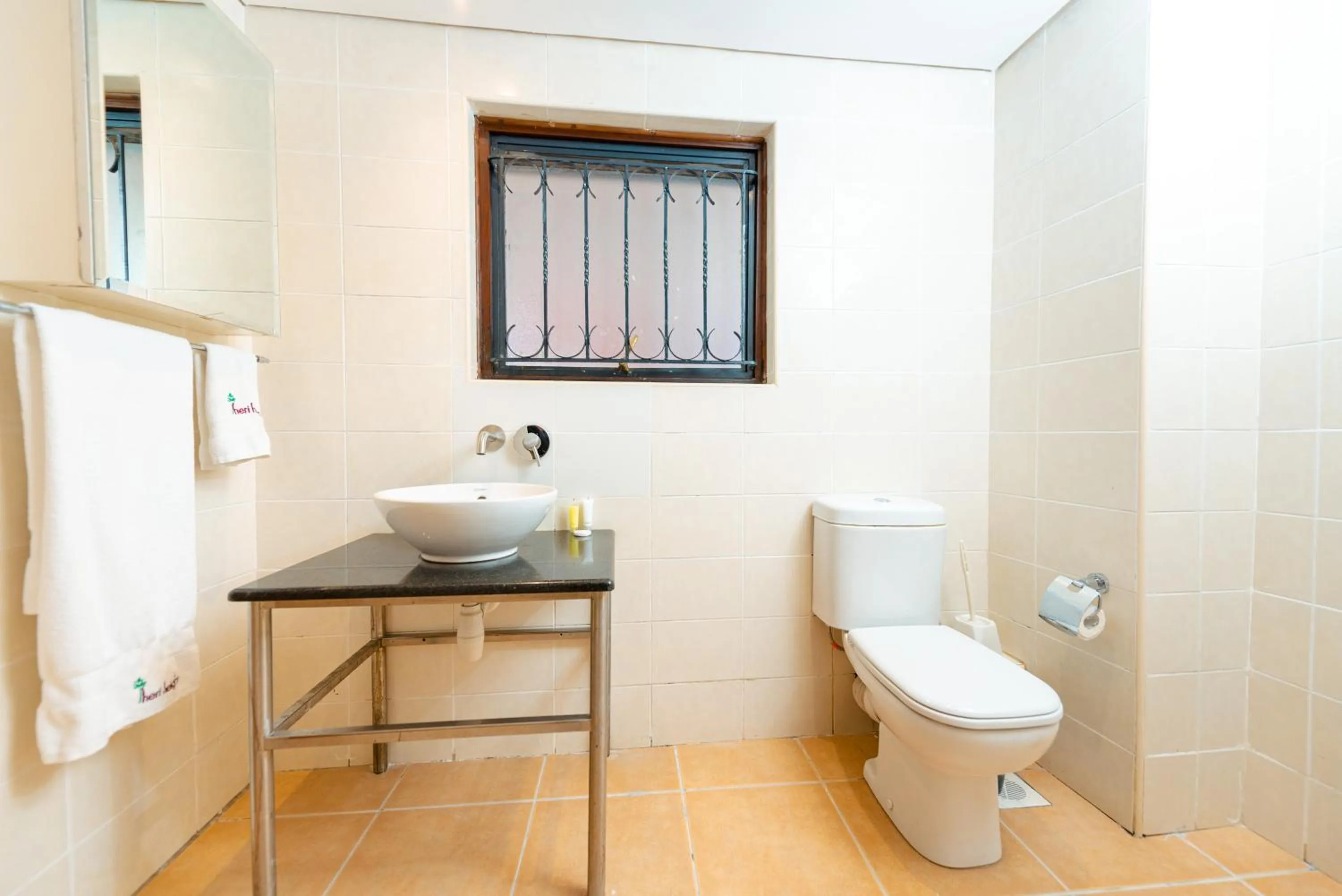 Bathroom in Heri Heights Hotel Apartments, SureStay Collection by Best Western