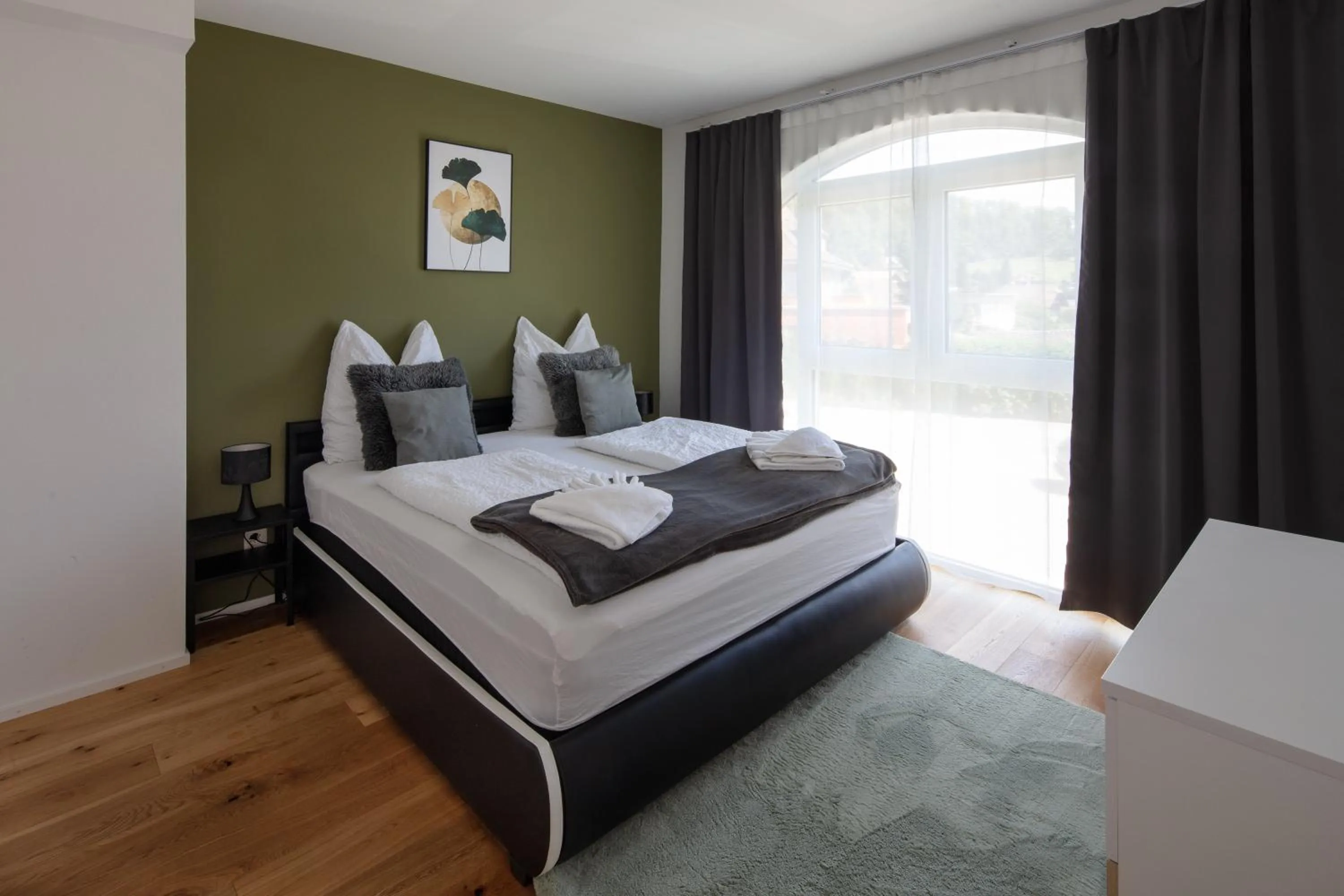 Bed in BERG & BERG APARTMENTS - Spiez Self-Check-in