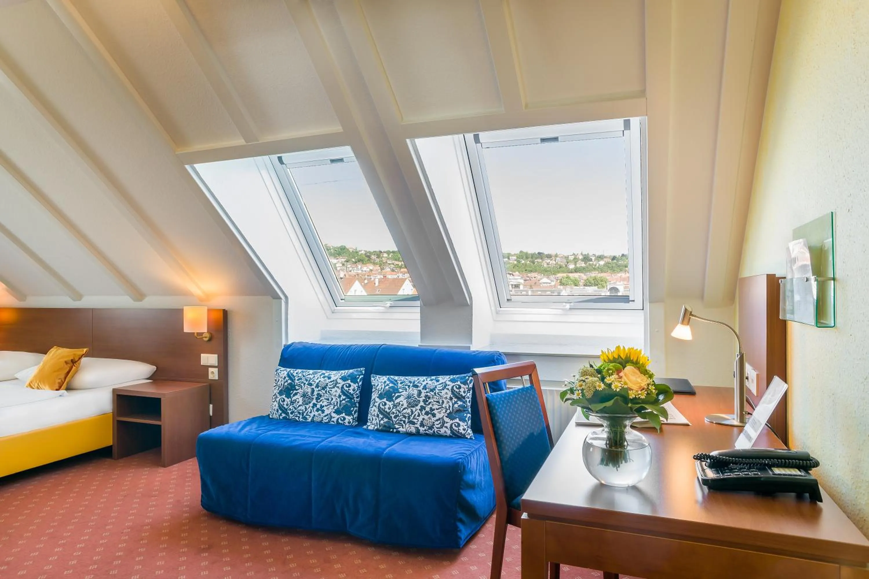 Seating area, Bed in Hotel Rega Stuttgart